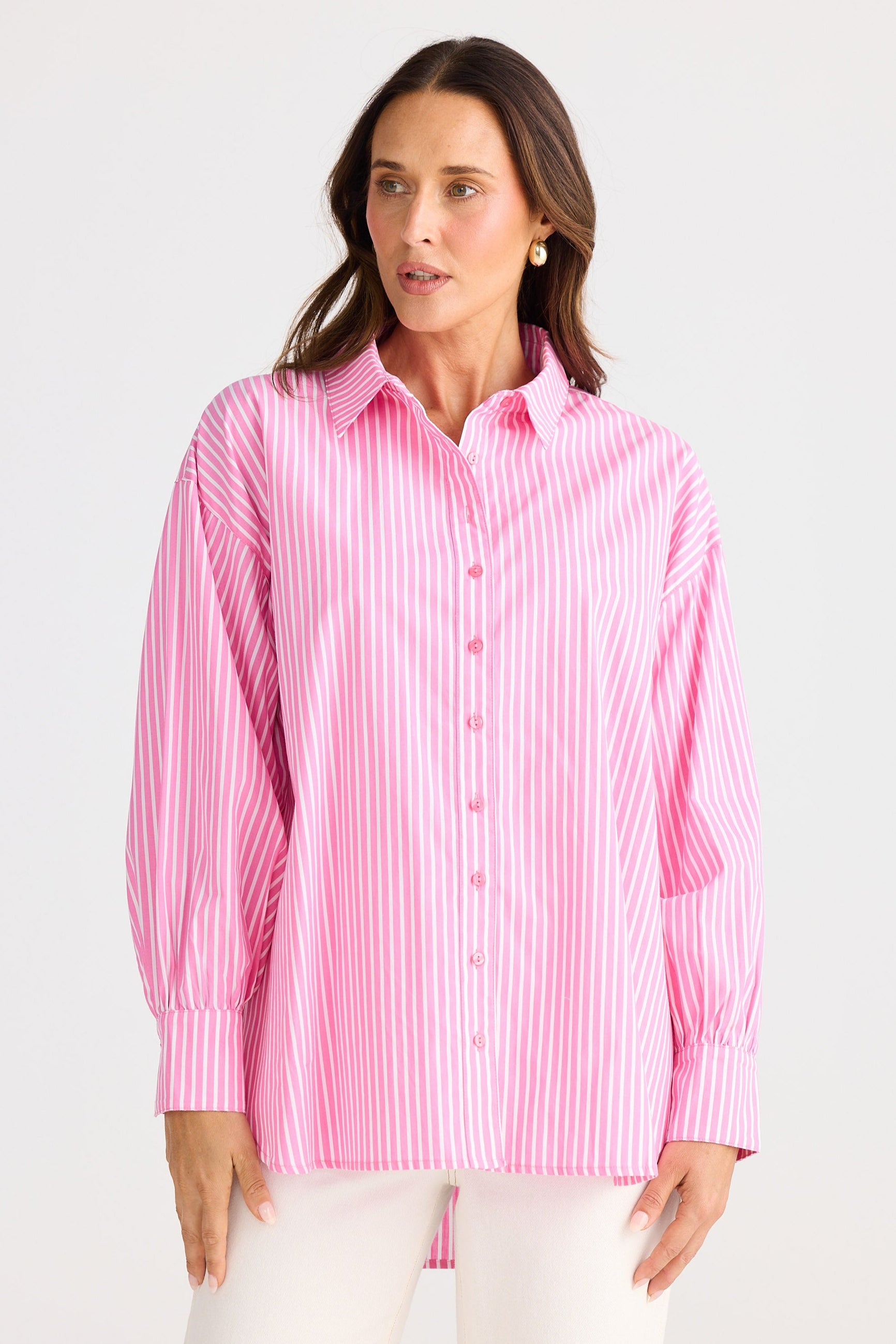 Woman wearing a pink striped shirt against a white background