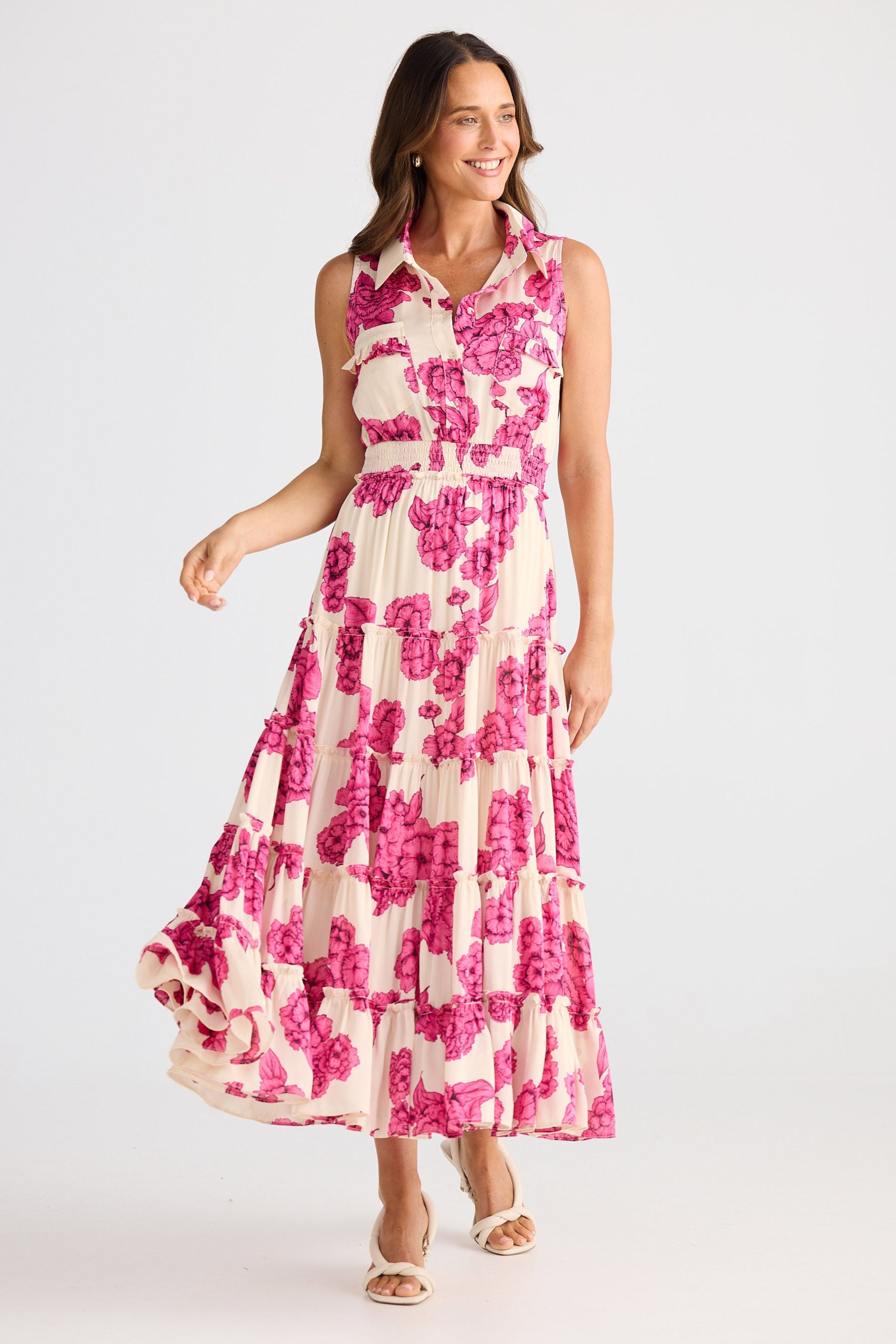 Woman wearing a pink floral dress on a white background