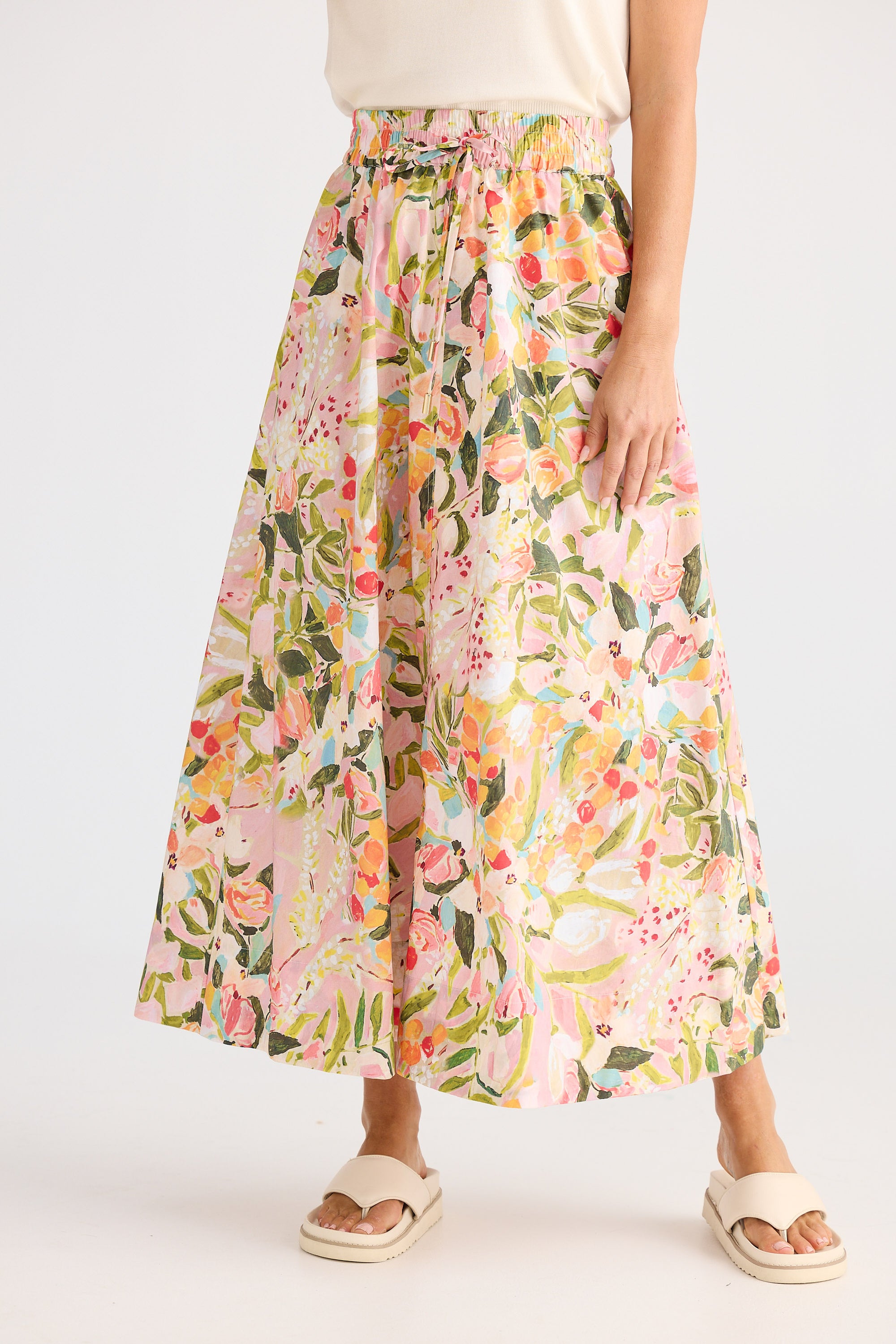 Floral patterned skirt worn by a person on a white background