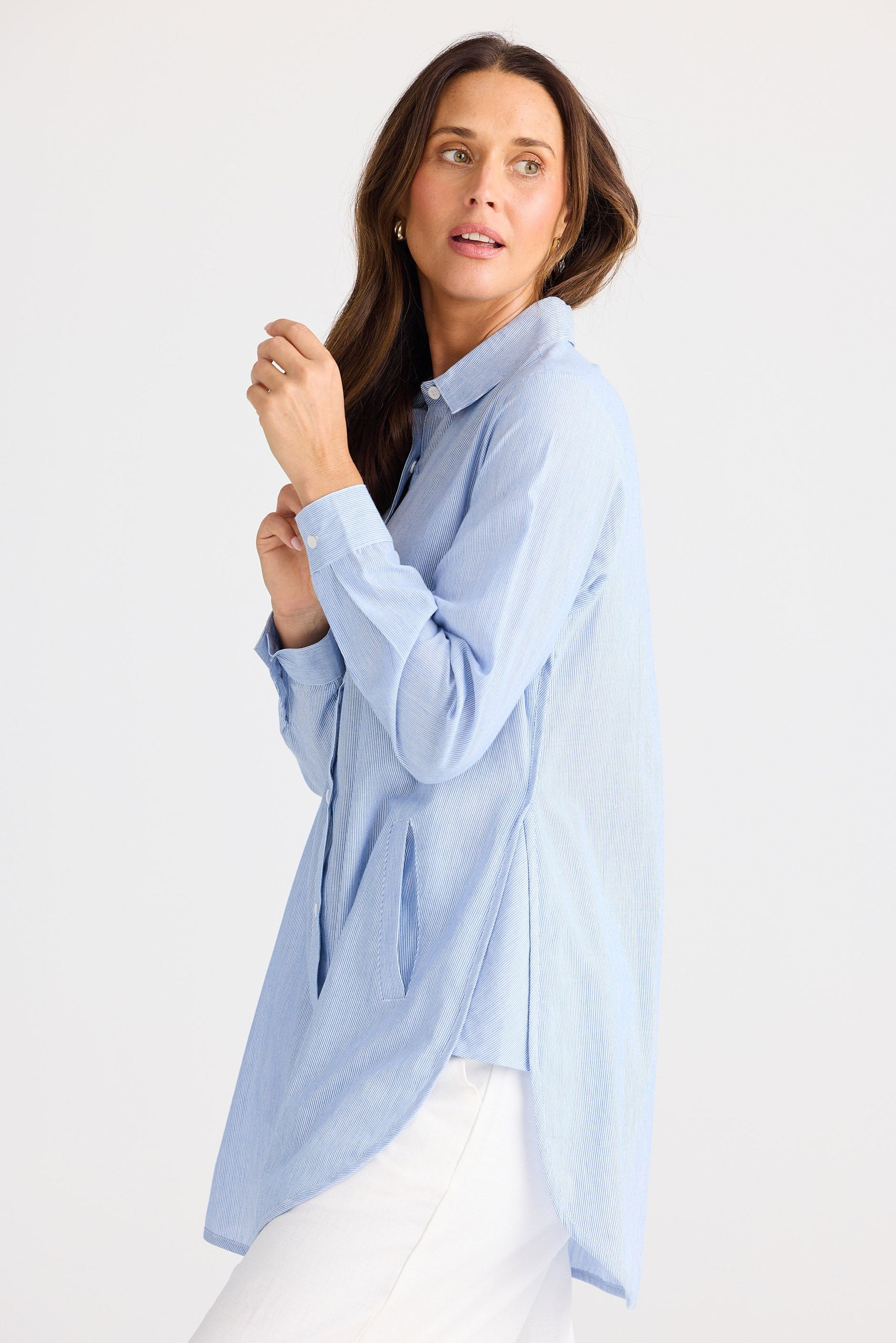 Woman wearing a light blue shirt on a white background