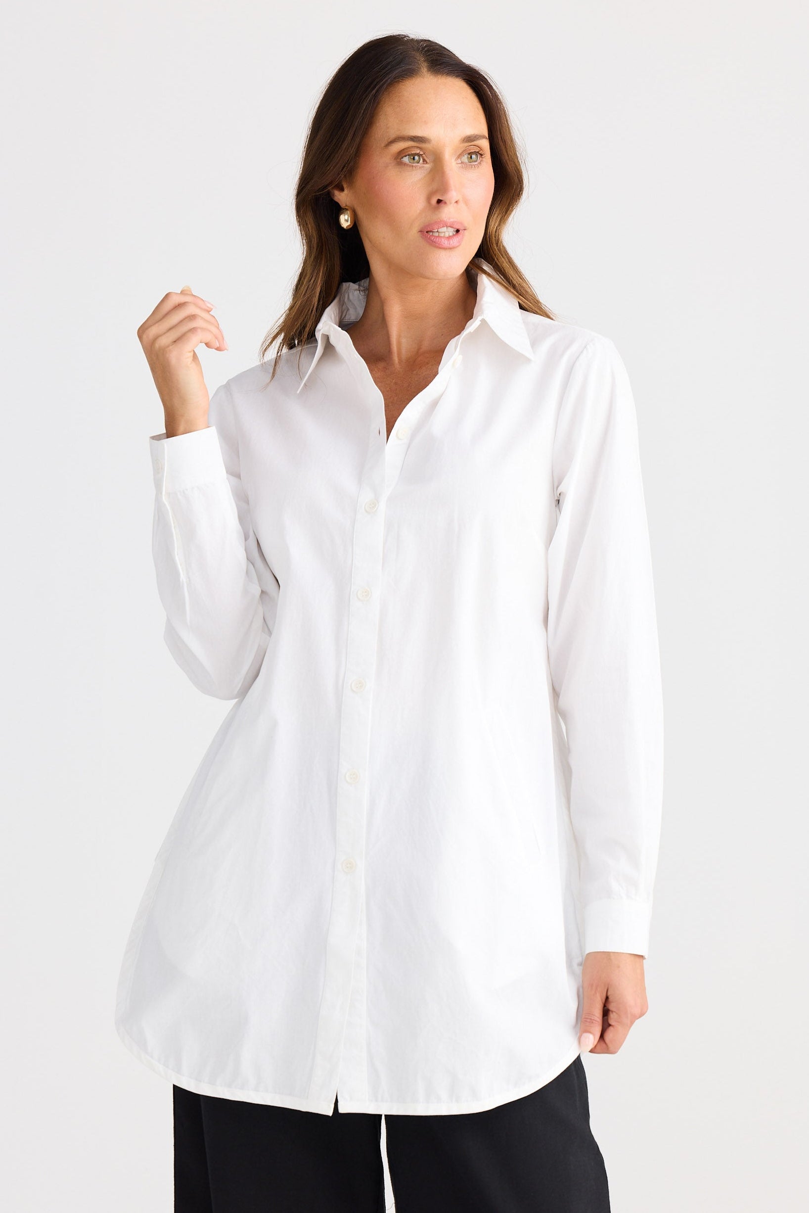 Woman wearing a white shirt and black pants on a white background