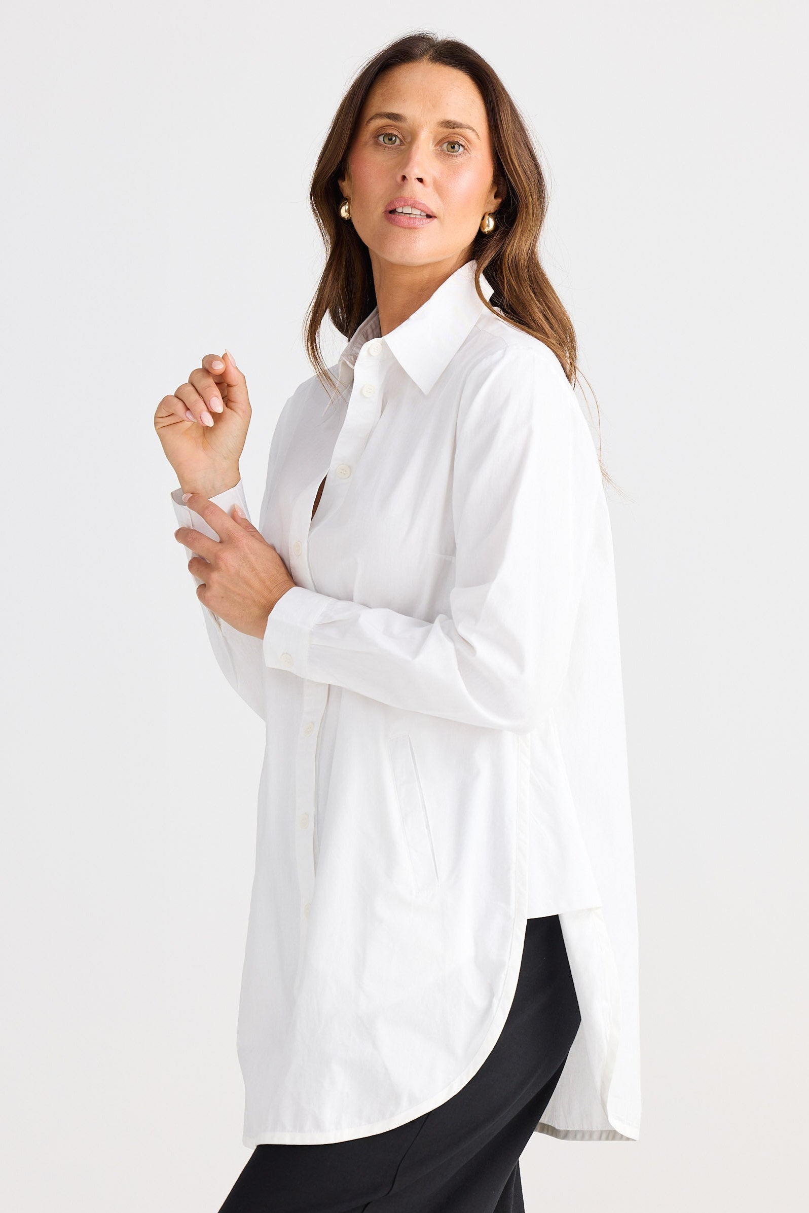 Woman wearing a white shirt on a plain background