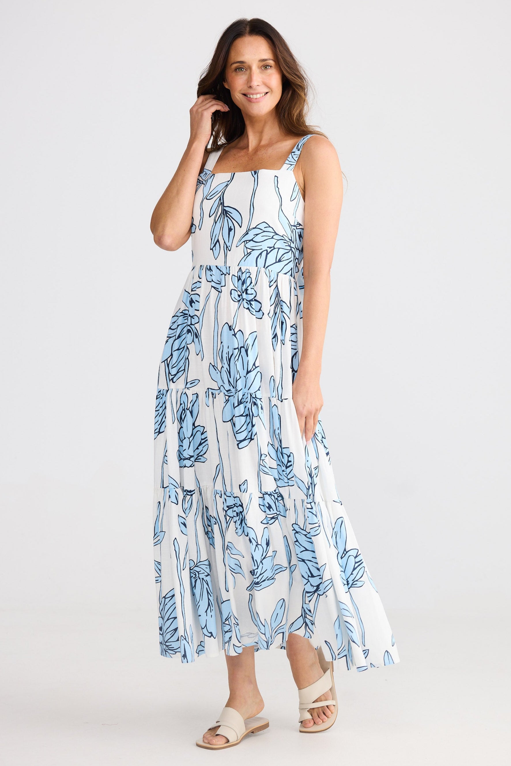 Woman wearing a blue floral dress on a white background