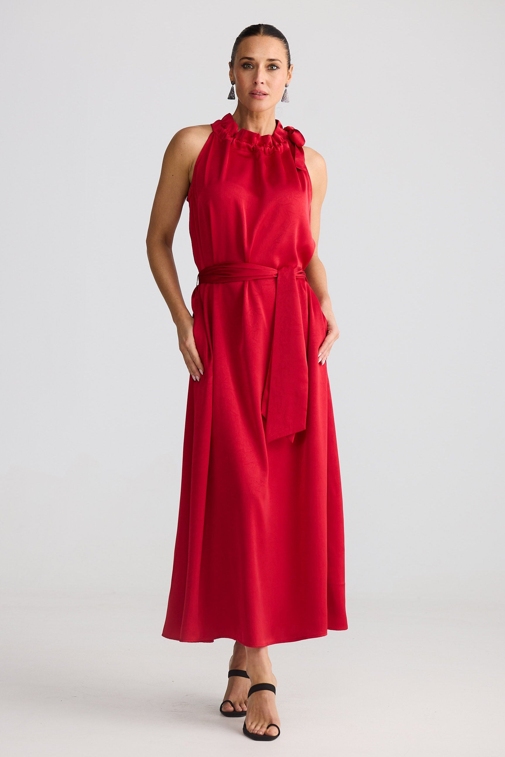 Woman wearing a red dress against a white background