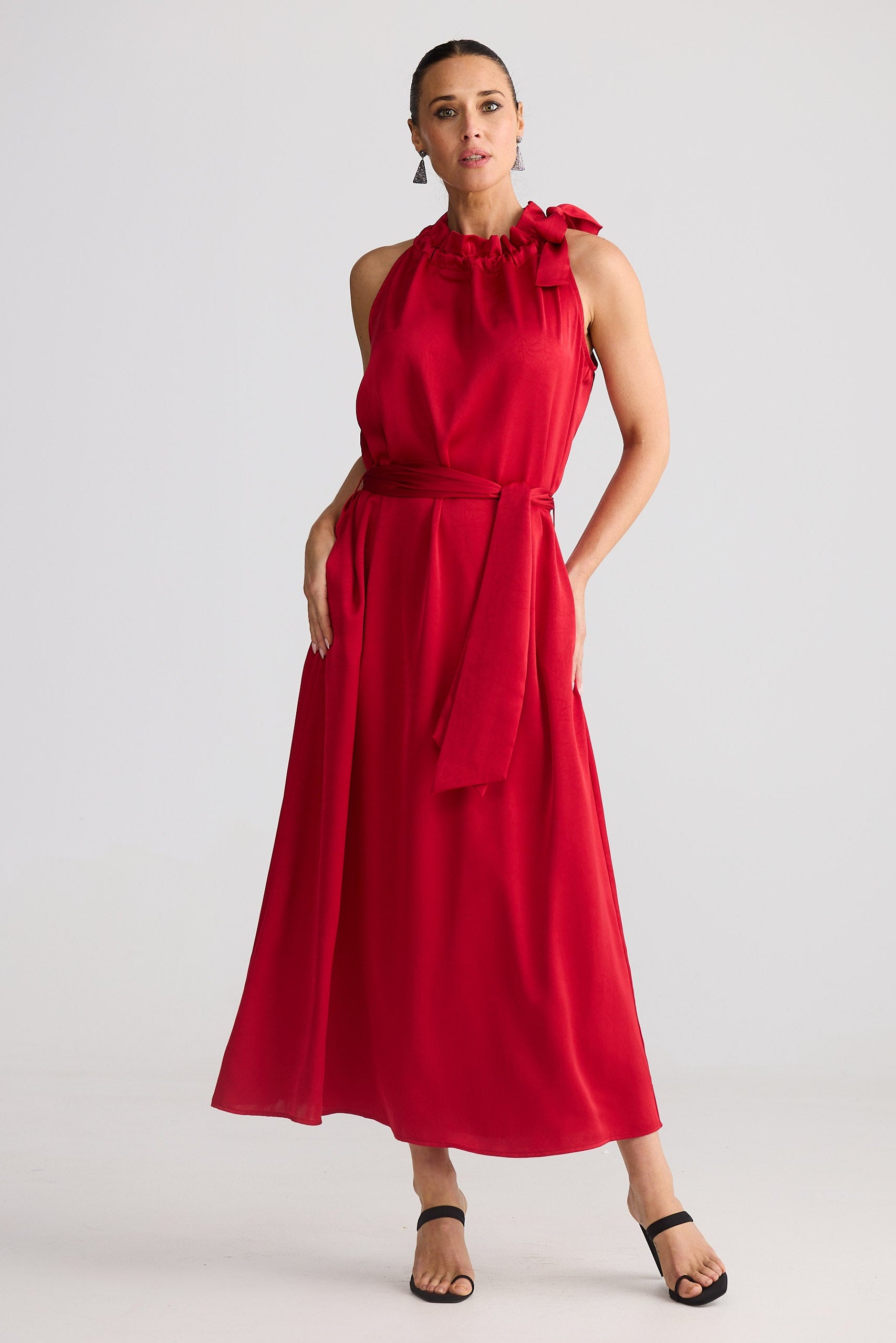 Woman wearing a red dress against a white background