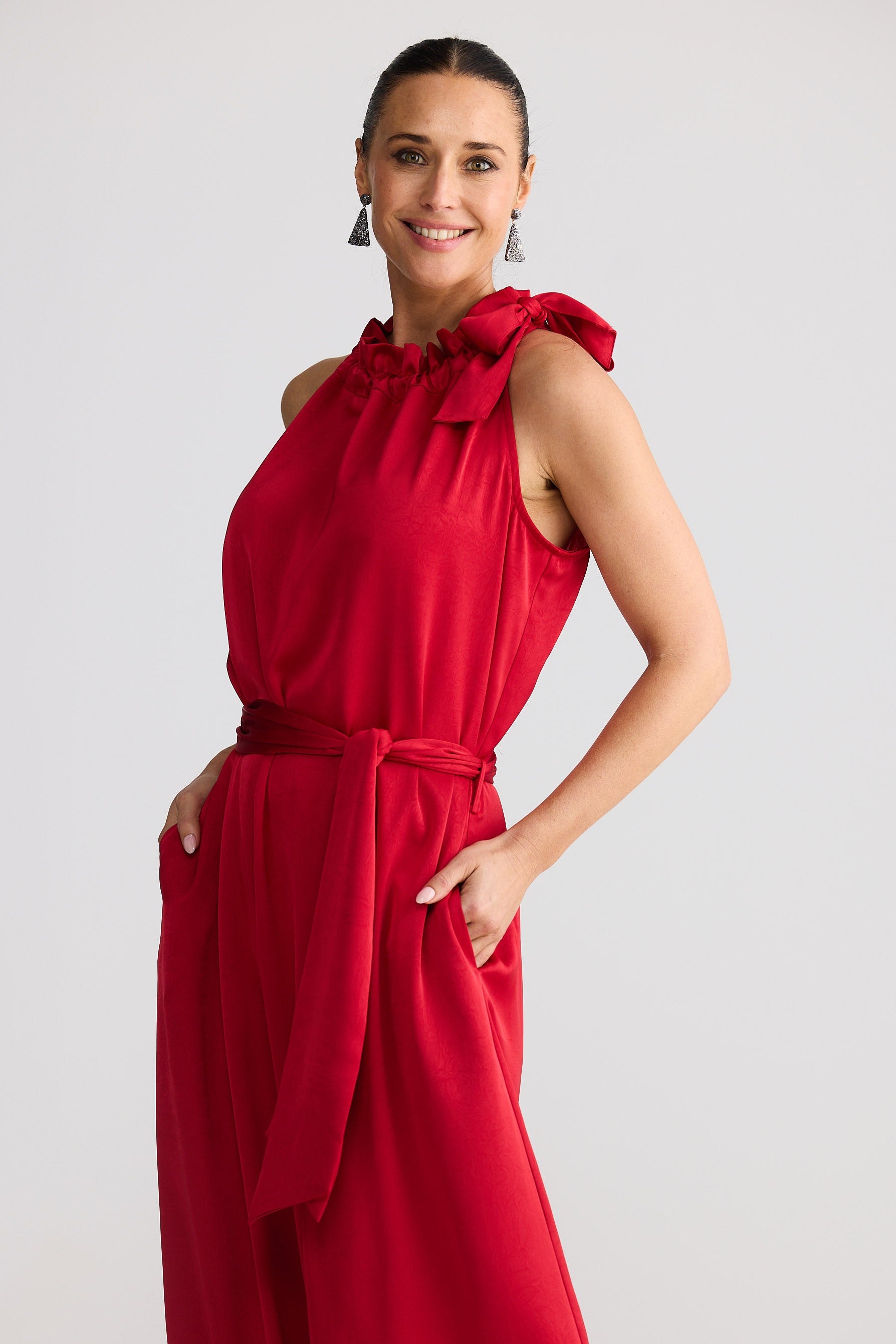 Woman wearing a red dress against a white background