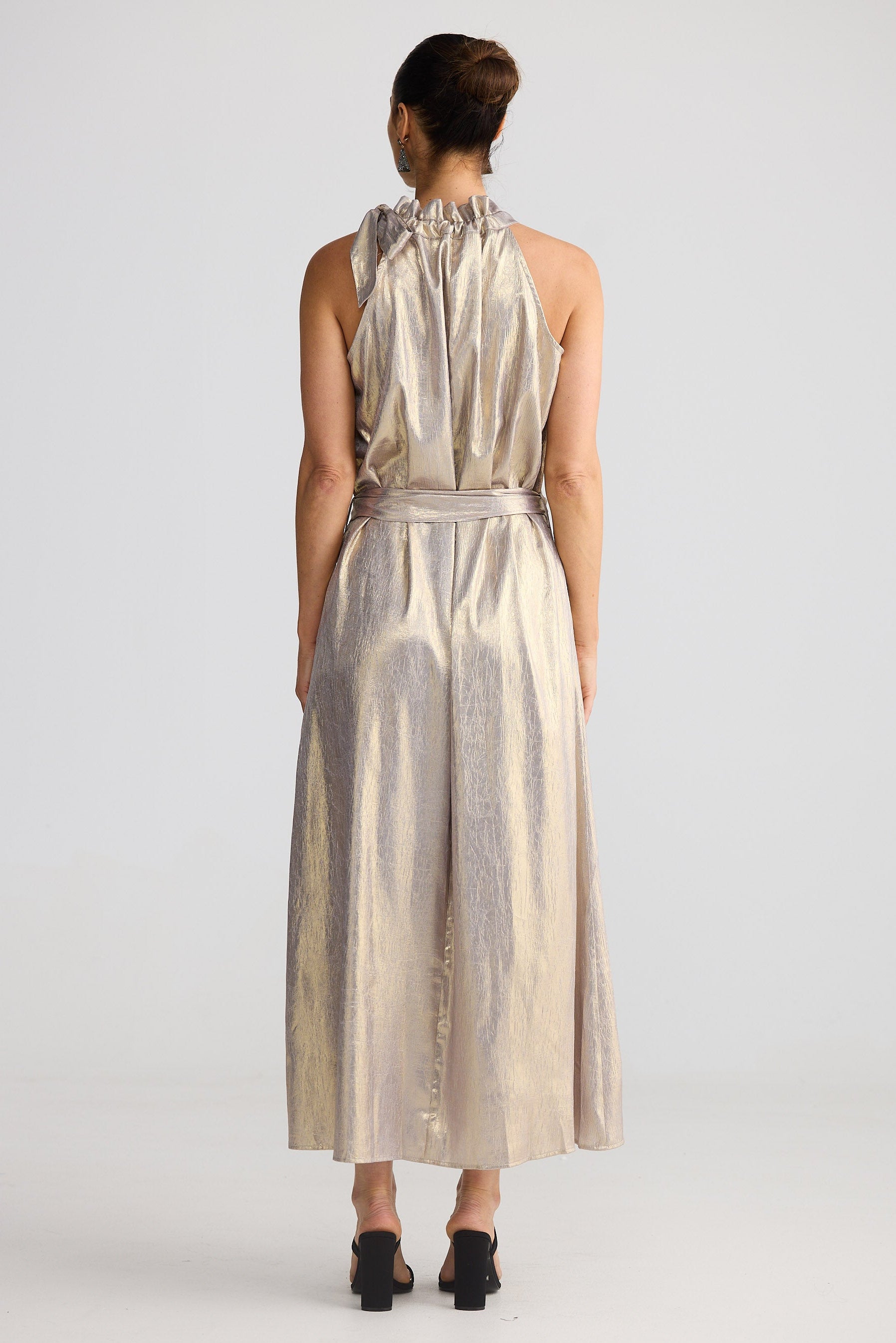 Woman wearing a striped dress from behind on a white background