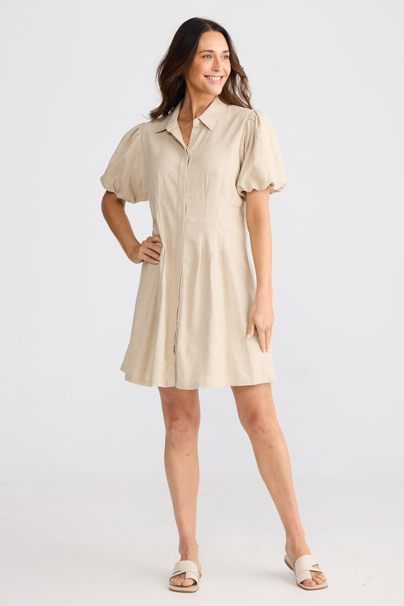 Woman wearing a beige dress on a white background