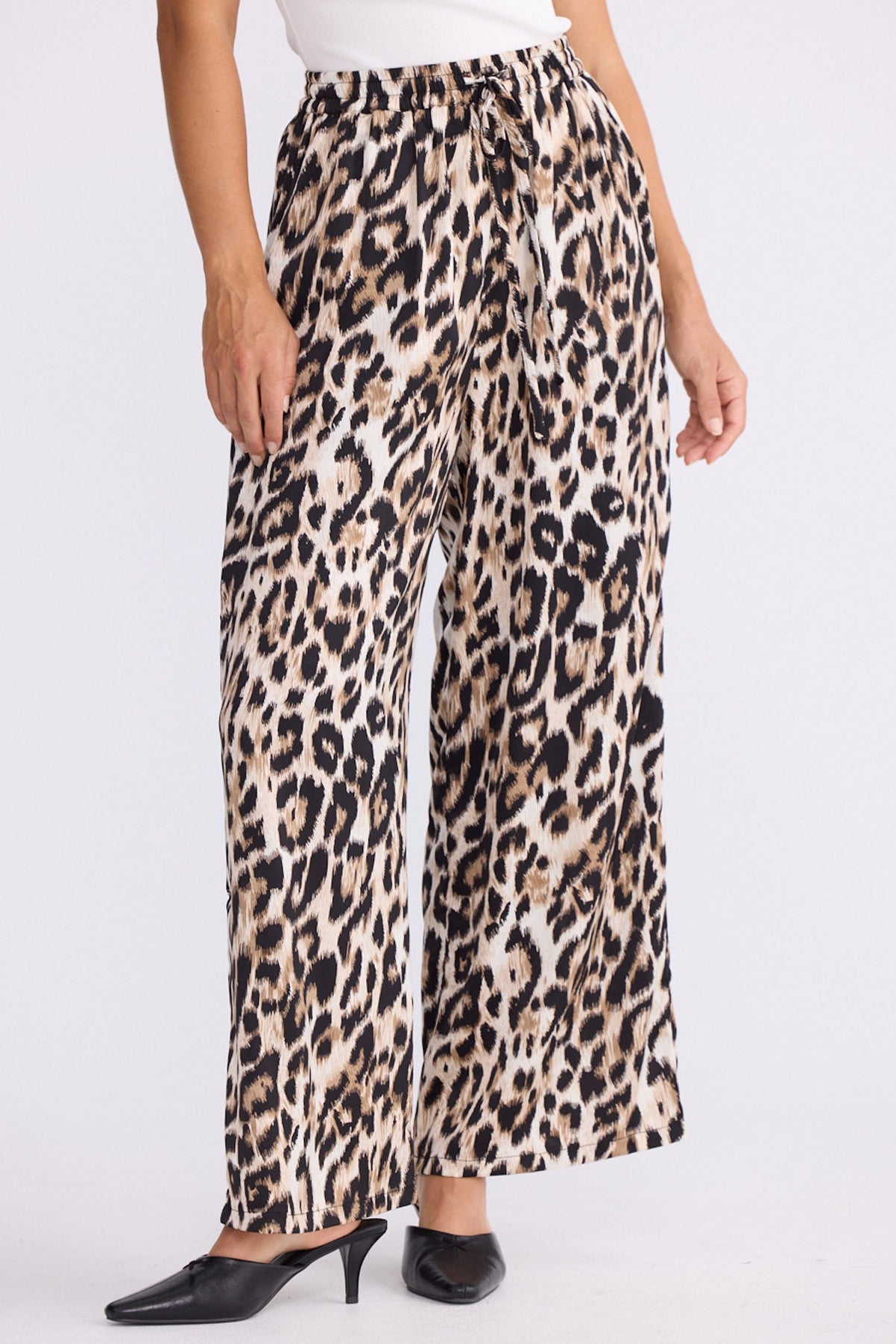 Model wearing Glenda Pant multicolour animal-print pants, straight-leg fit, front view on white background