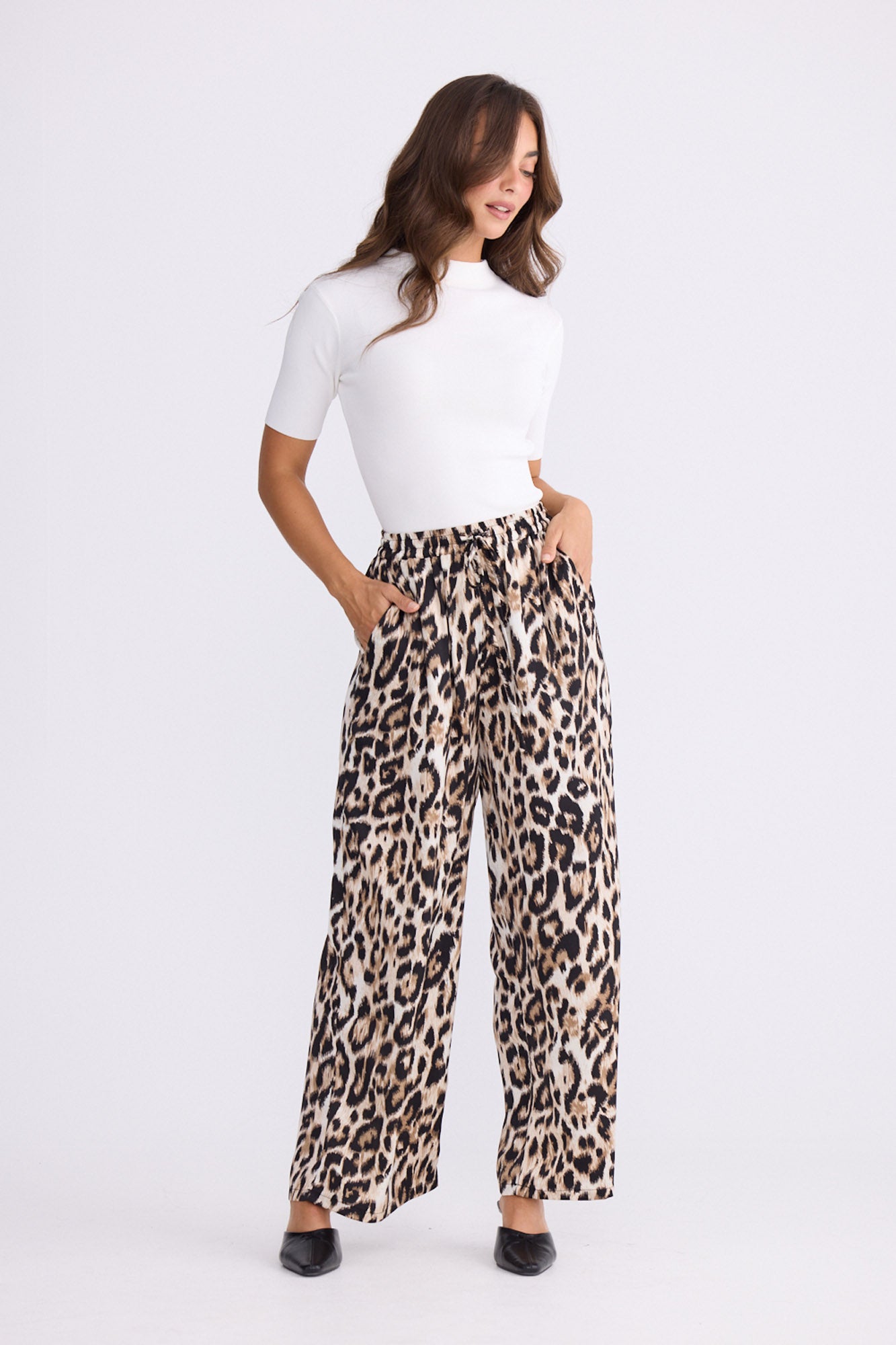 Model wearing Glenda Pant multicolour animal-print pants, straight-leg fit, alternate studio view on white background