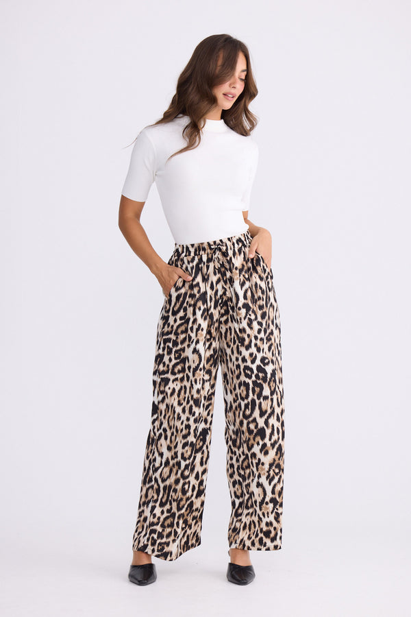 Model wearing Glenda Pant multicolour animal-print pants, straight-leg fit, alternate studio view on white background