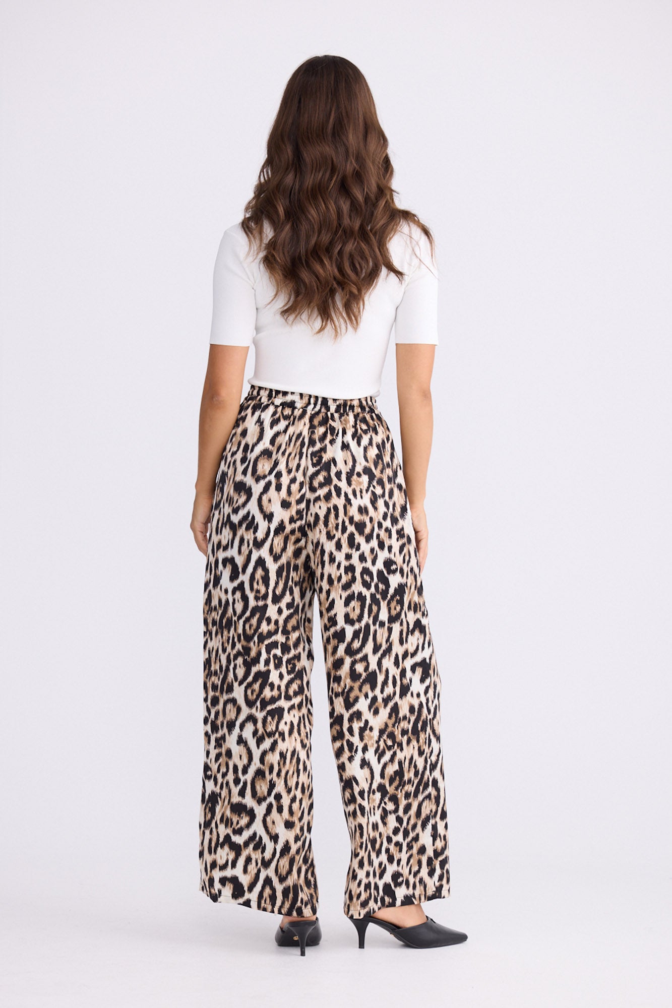 Model wearing Glenda Pant multicolour animal-print pants, straight-leg fit, alternate studio view on white background