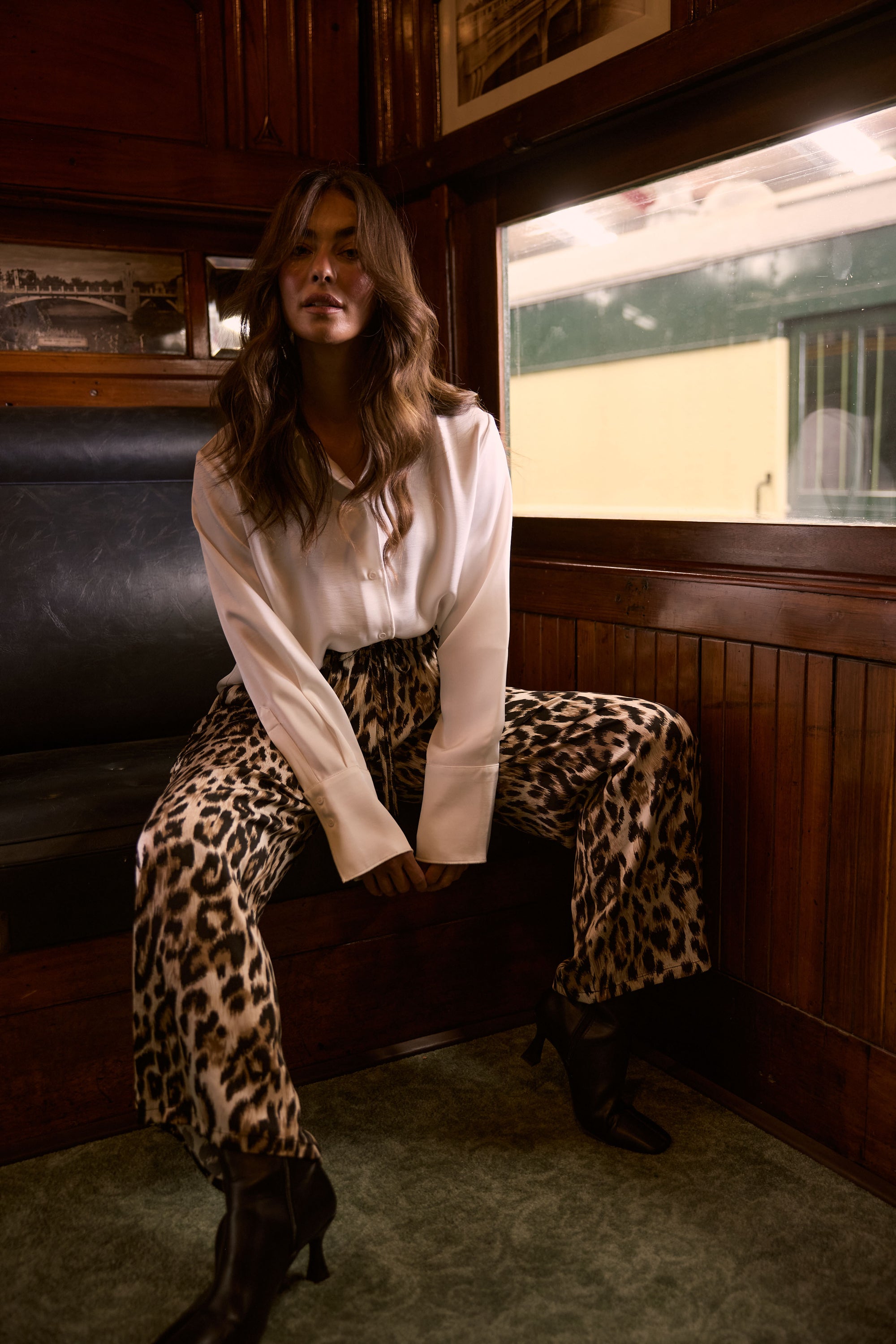 Model wearing Glenda Pant multicolour animal-print pants, straight-leg fit, alternate studio view on white background