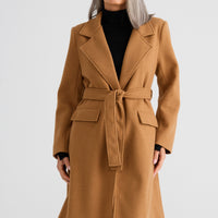 Woman wearing a brown coat on a white background