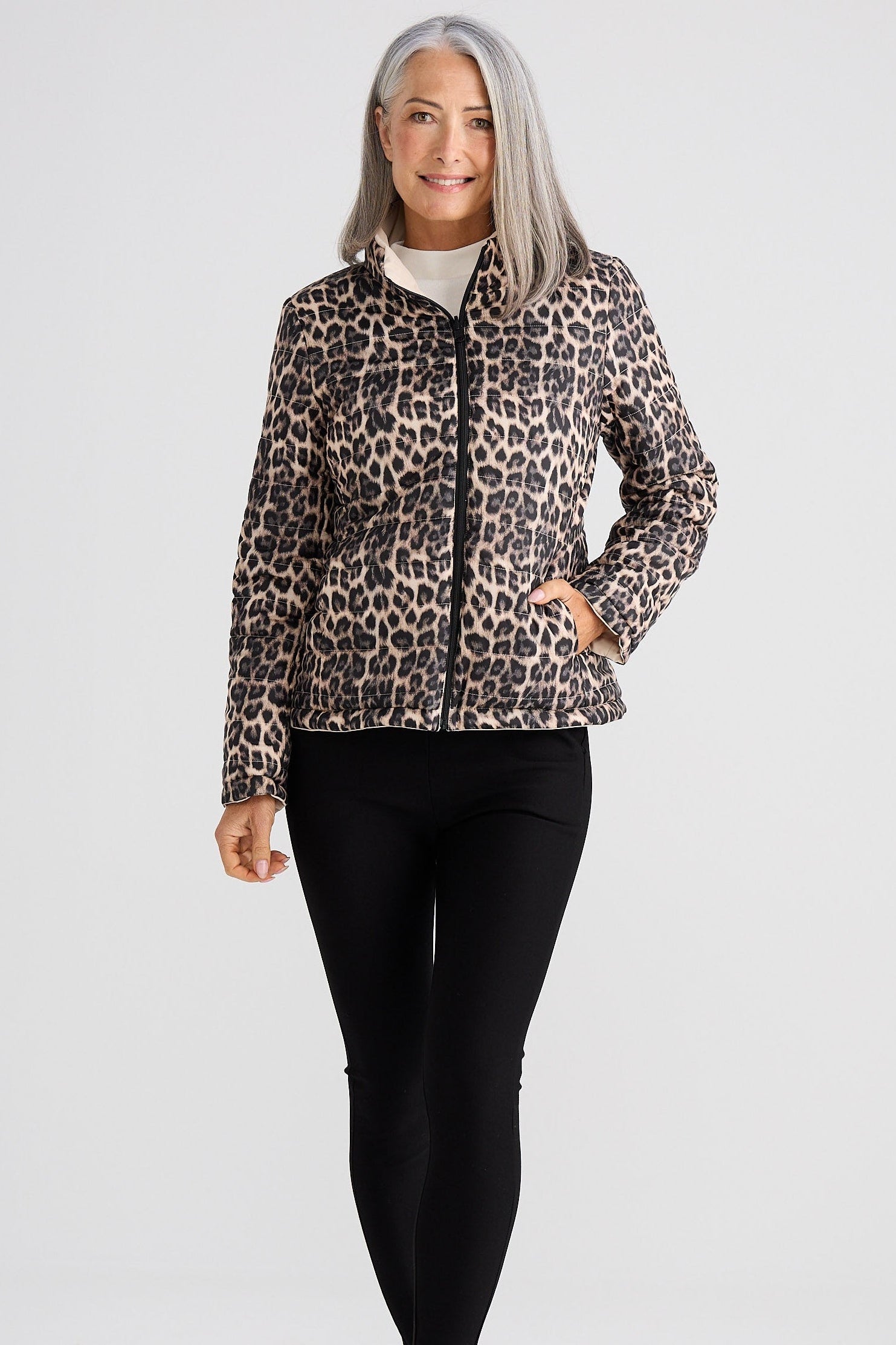 Woman wearing a leopard print jacket on a white background