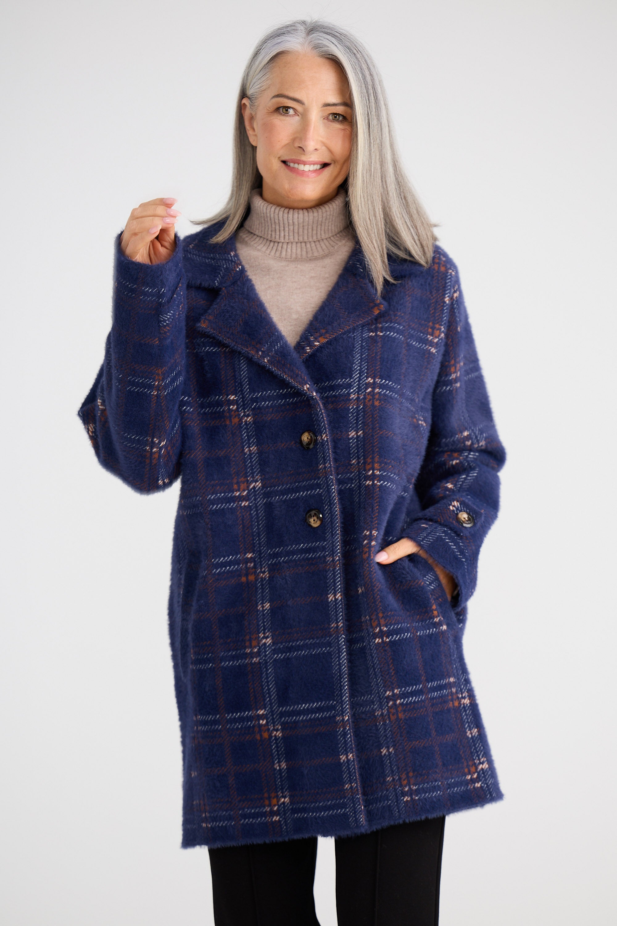 Woman wearing a blue plaid coat on a white background