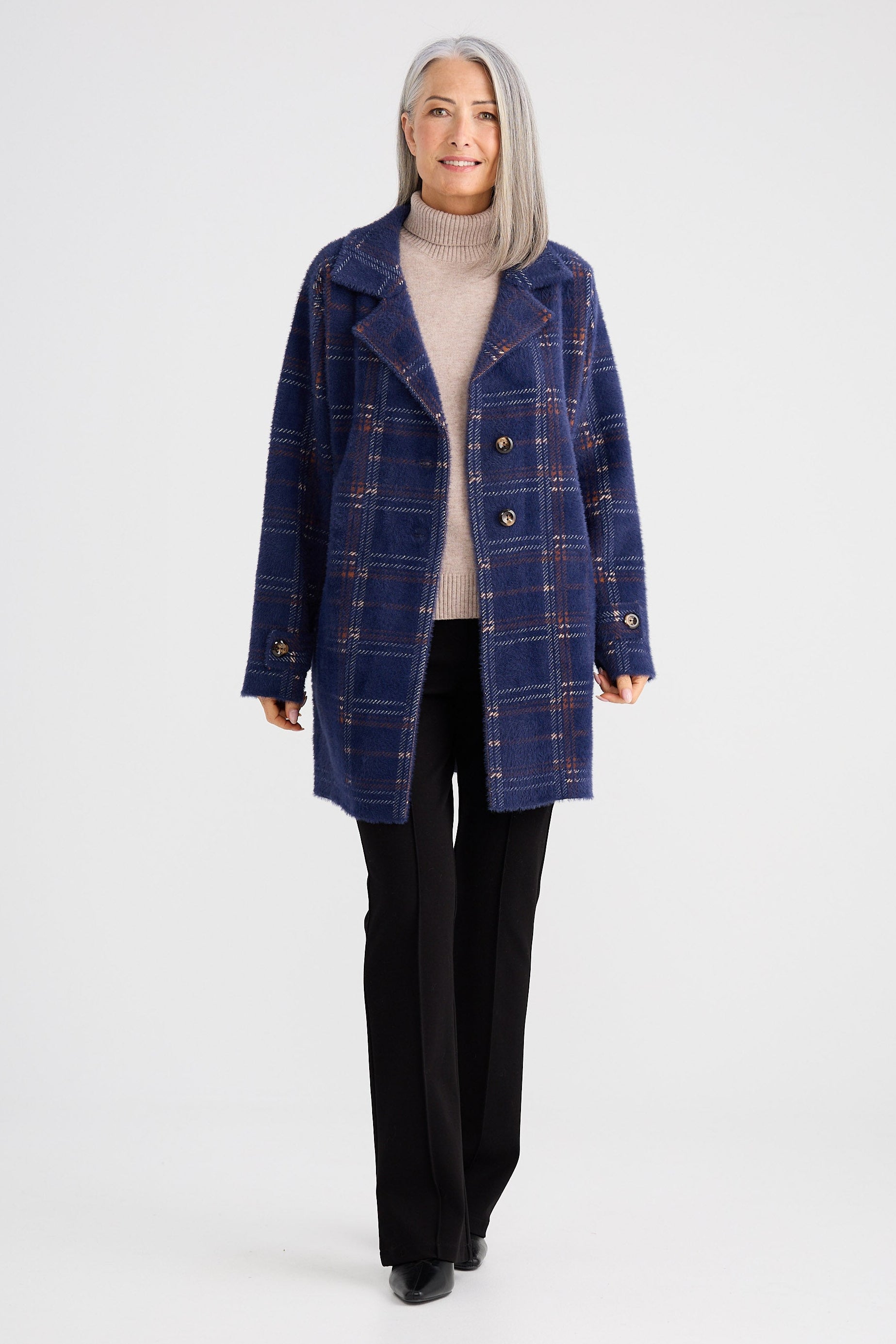 Woman wearing a blue plaid coat on a white background