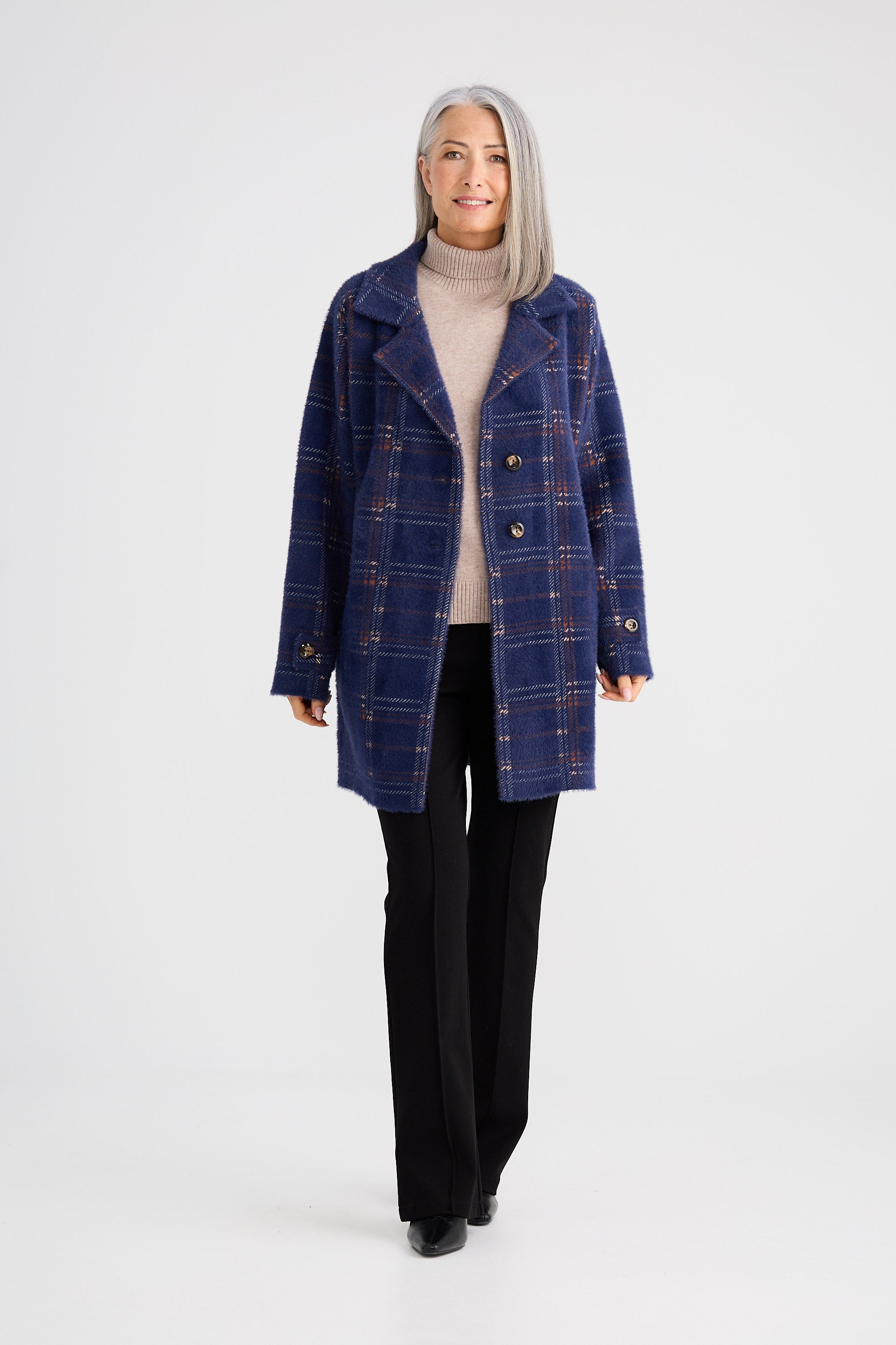 Woman wearing a blue plaid coat on a white background