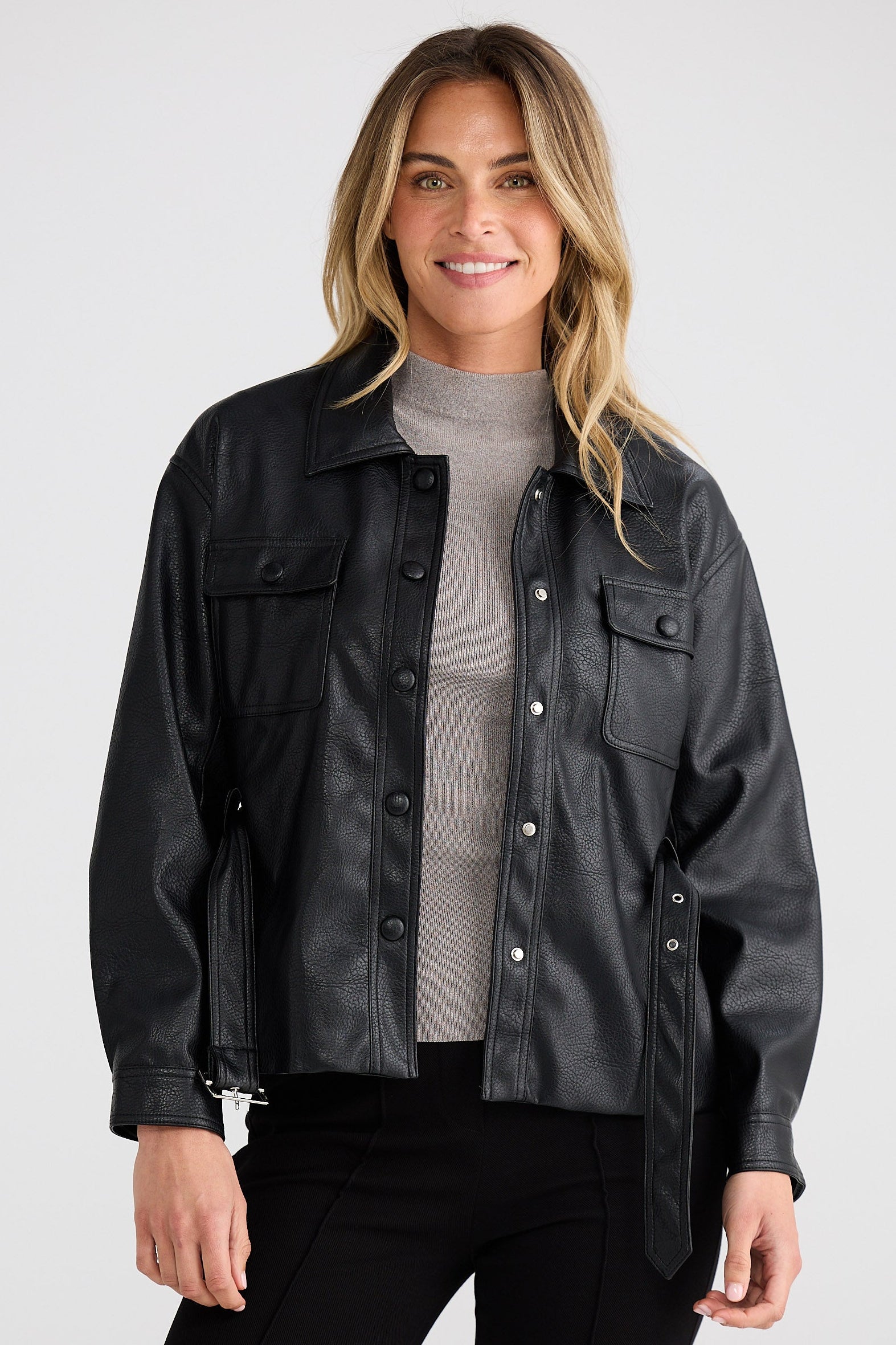 Woman wearing a black leather jacket on a white background