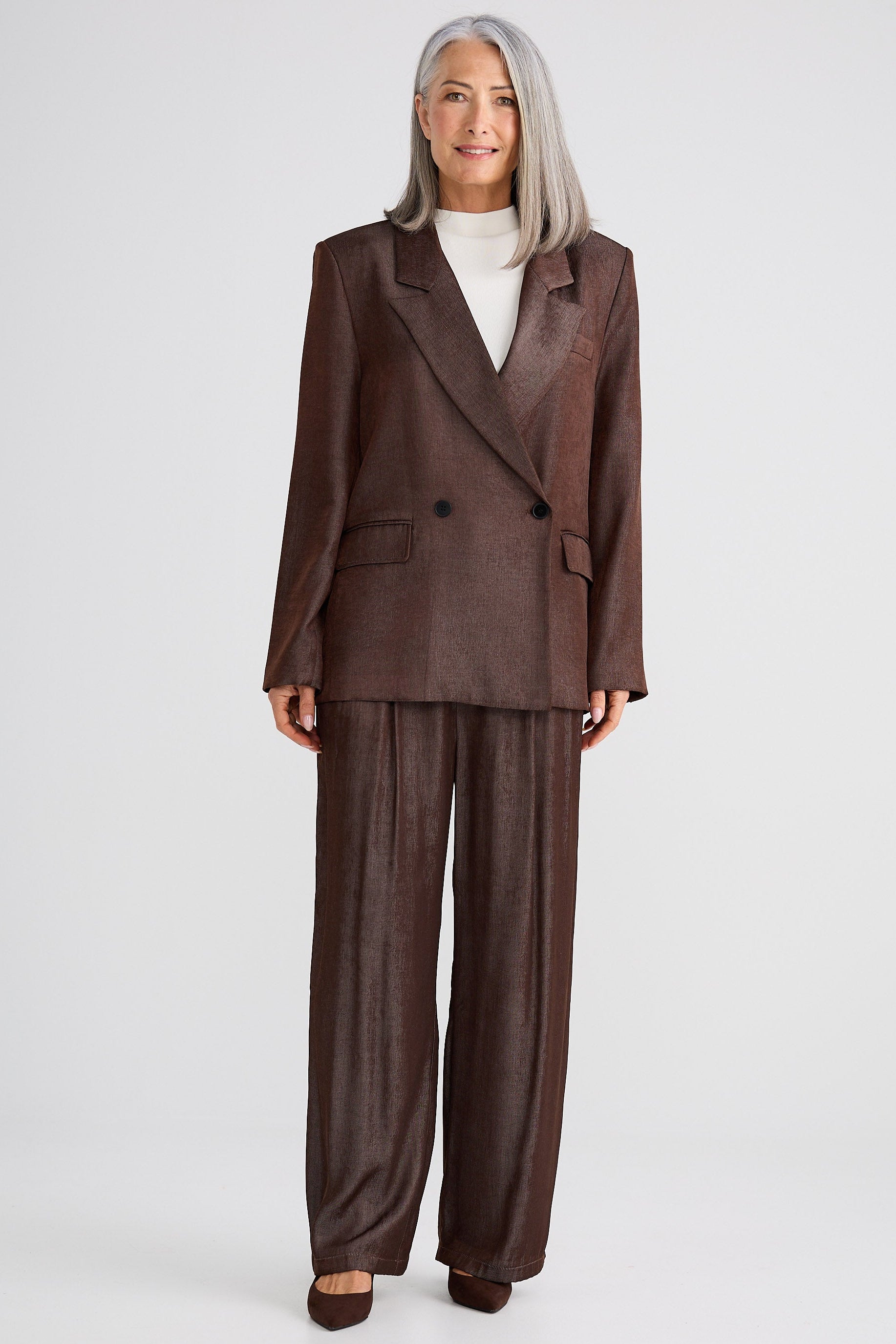 Woman wearing a brown suit on a white background