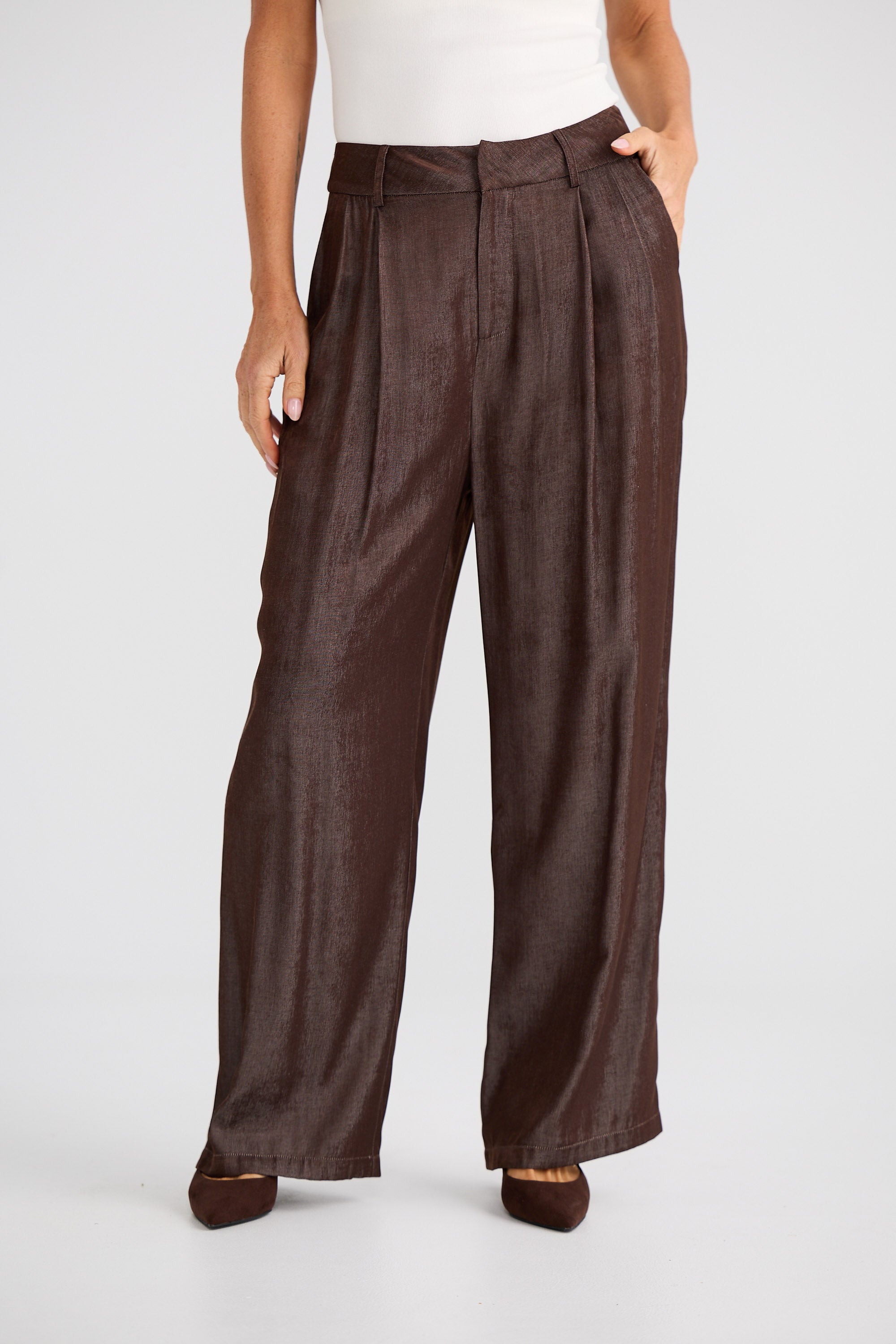 Brown wide-leg pants worn by a person on a white background