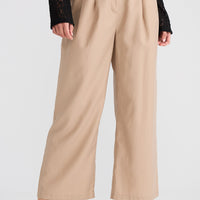 Beige wide-leg pants worn by a person on a white background