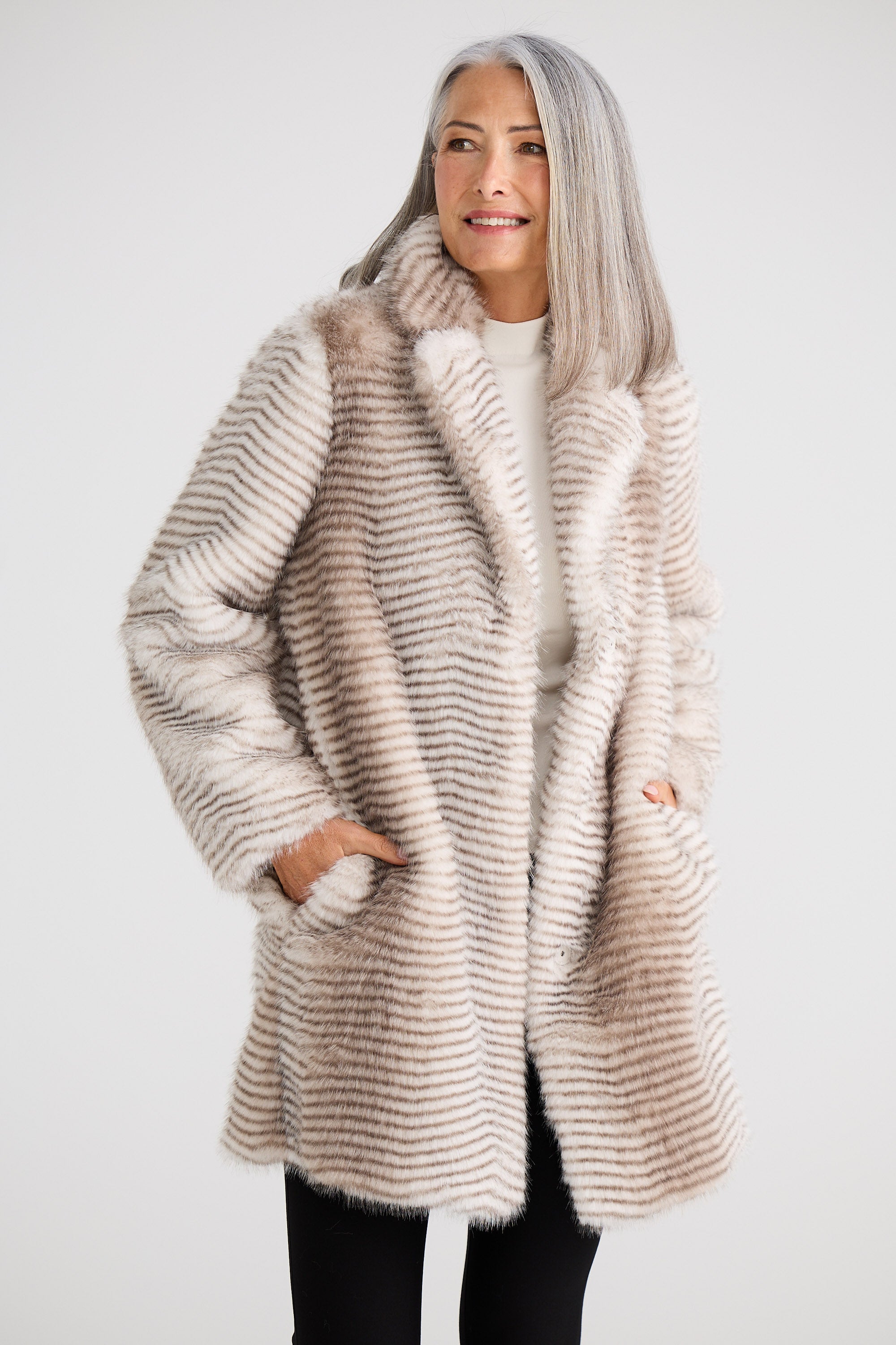 Woman wearing a fur coat against a white background