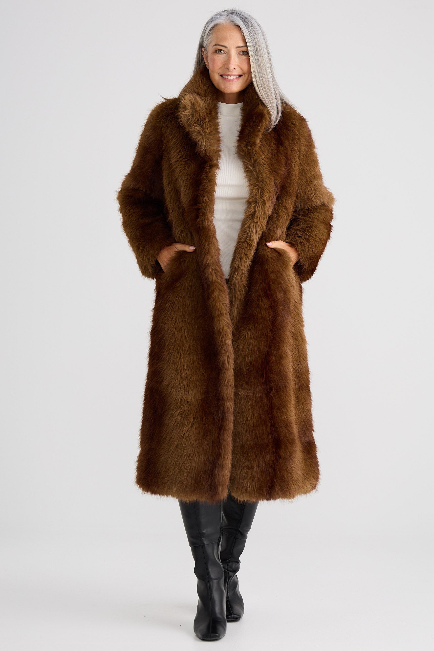 Person wearing a brown fur coat on a white background