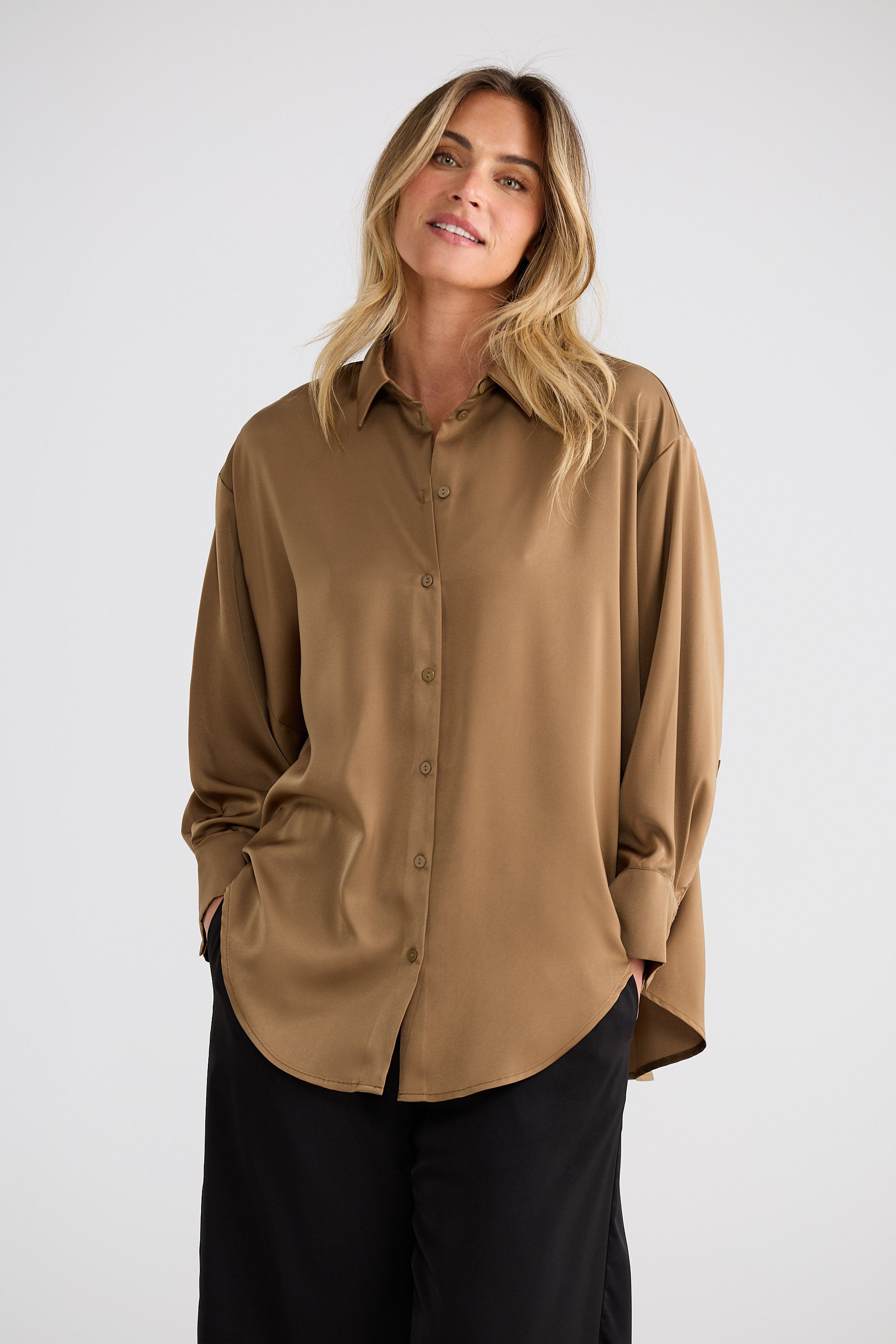 Woman wearing a beige shirt against a white background