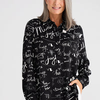 Woman wearing a black shirt with white text patterns on a white background