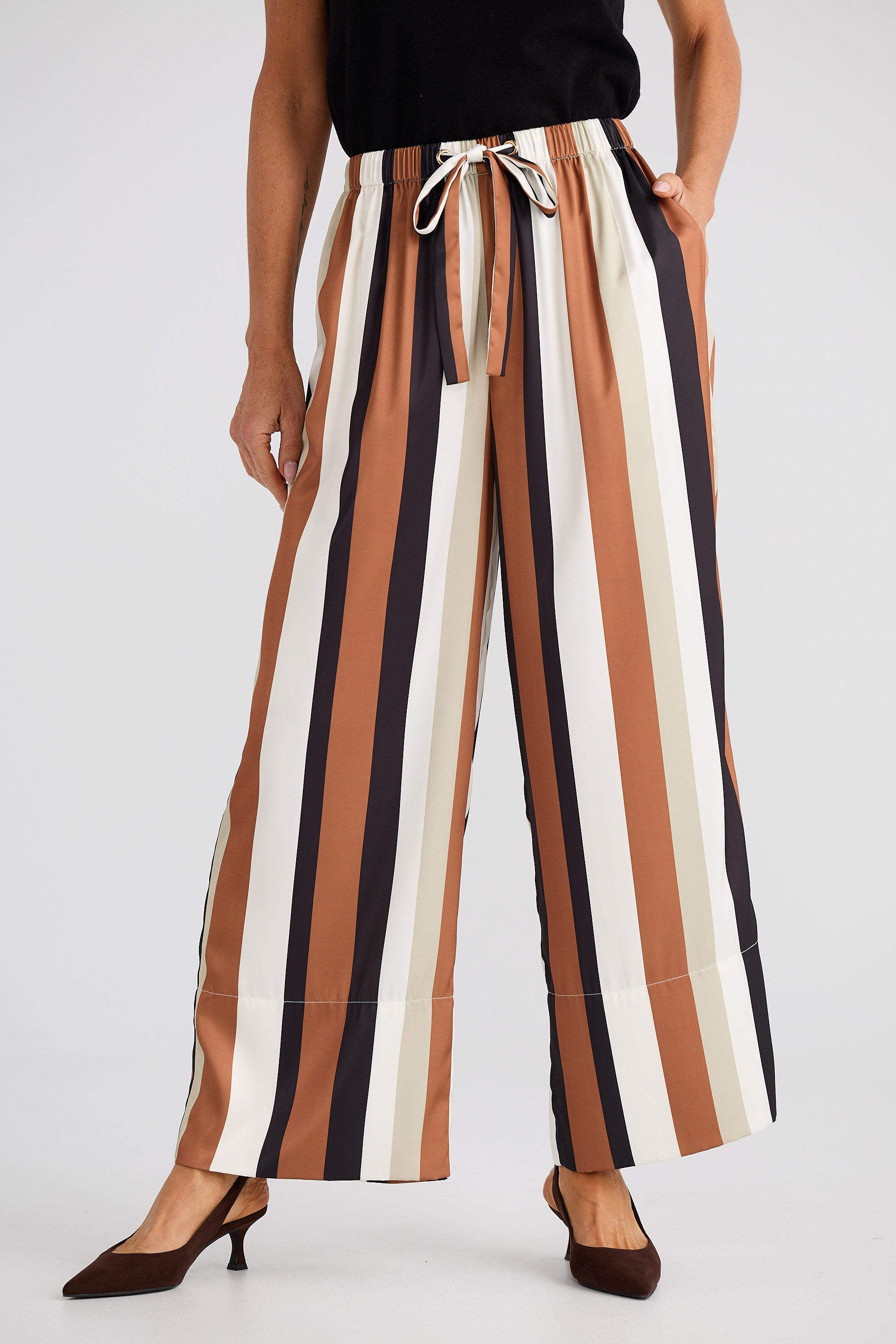 Striped pants worn by a person on a white background