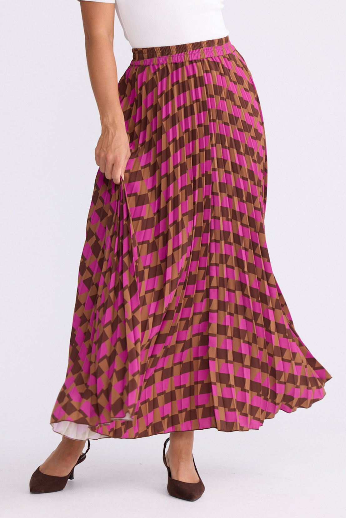 Model wearing Alias Pleated Skirt multicolour geometric-print skirt with permanent pleated finish, front view on white background