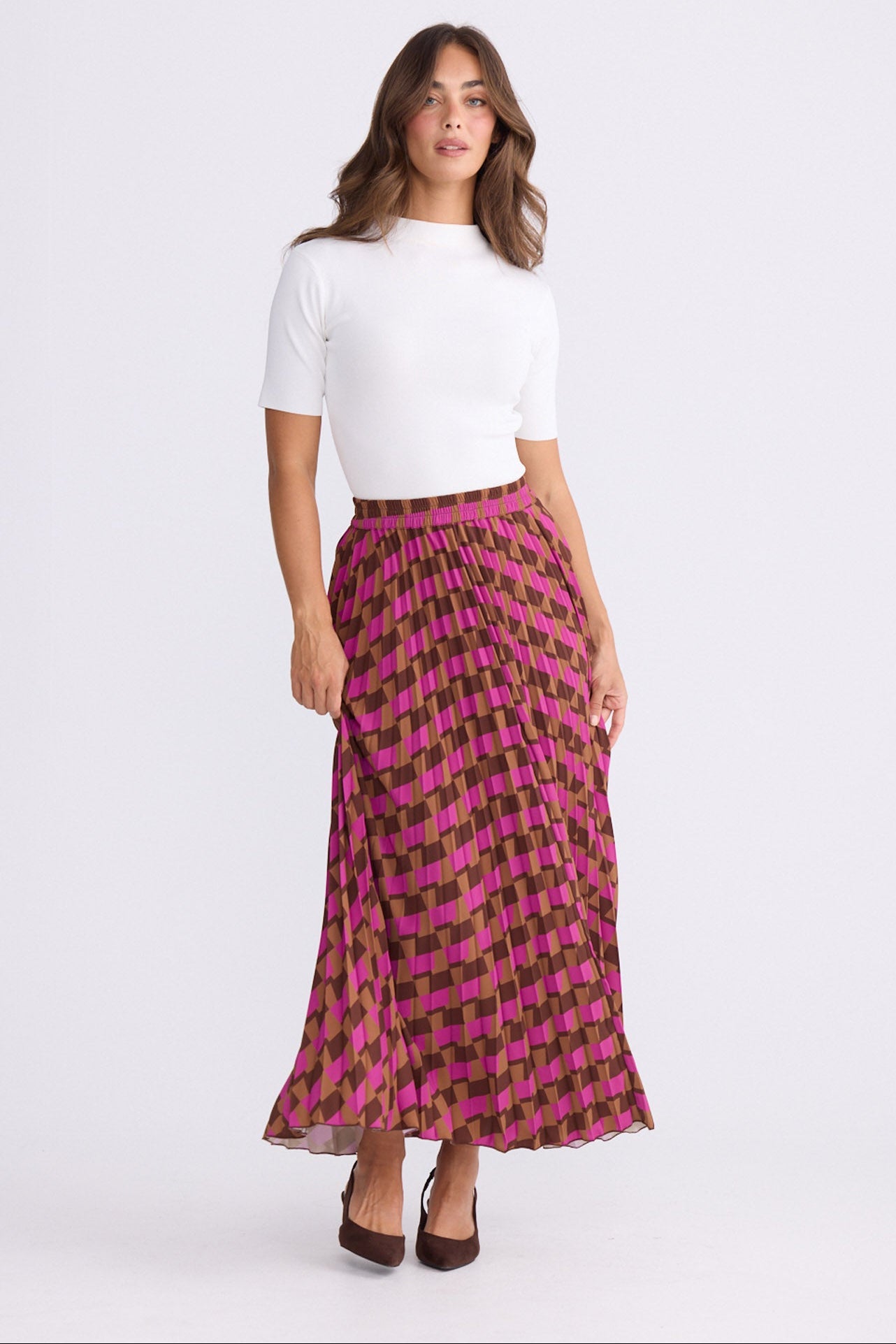 Model wearing Alias Pleated Skirt multicolour geometric-print skirt, alternate studio view on white background
