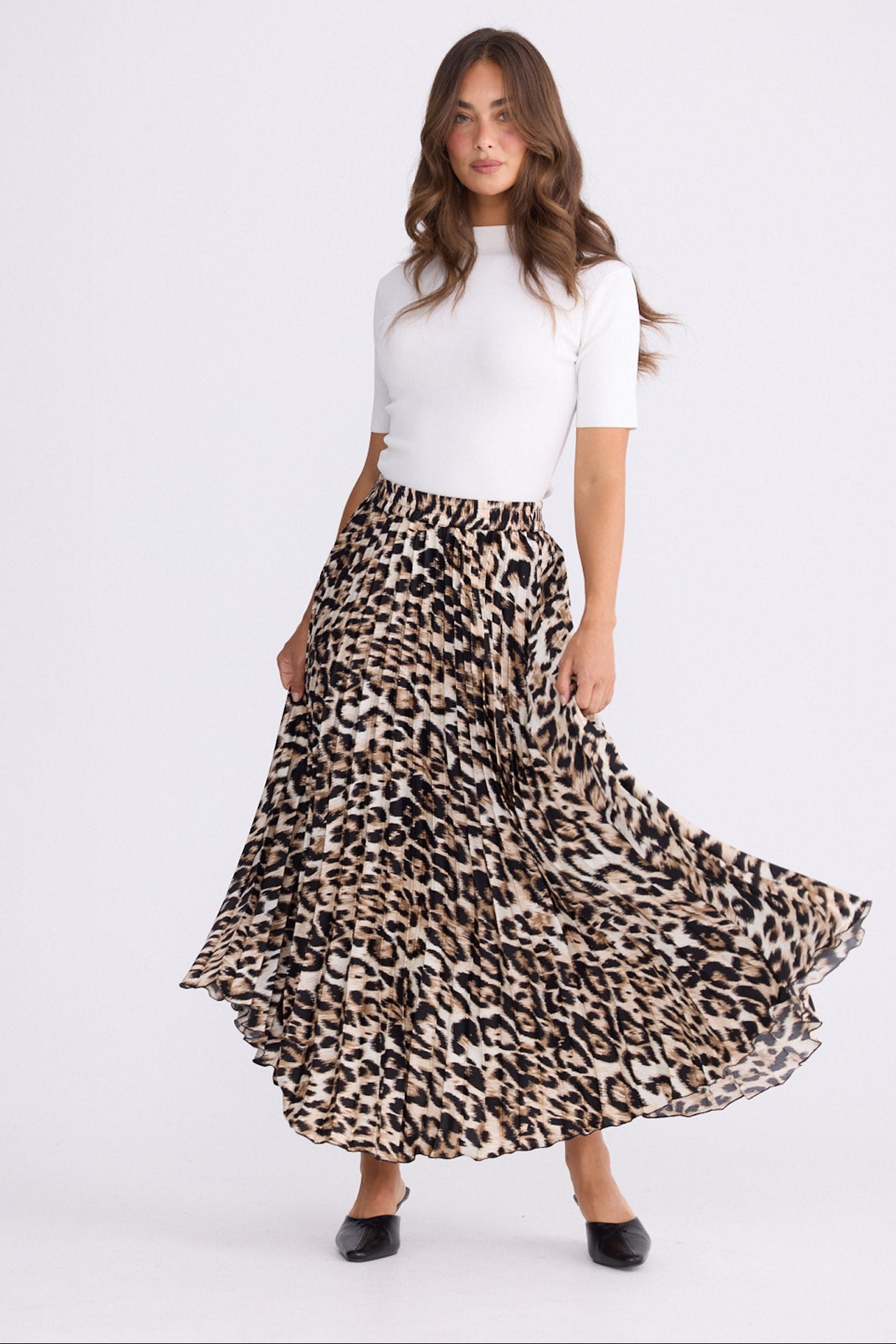 Model wearing Alias Pleated Skirt multicolour animal-print skirt, alternate studio view on white background