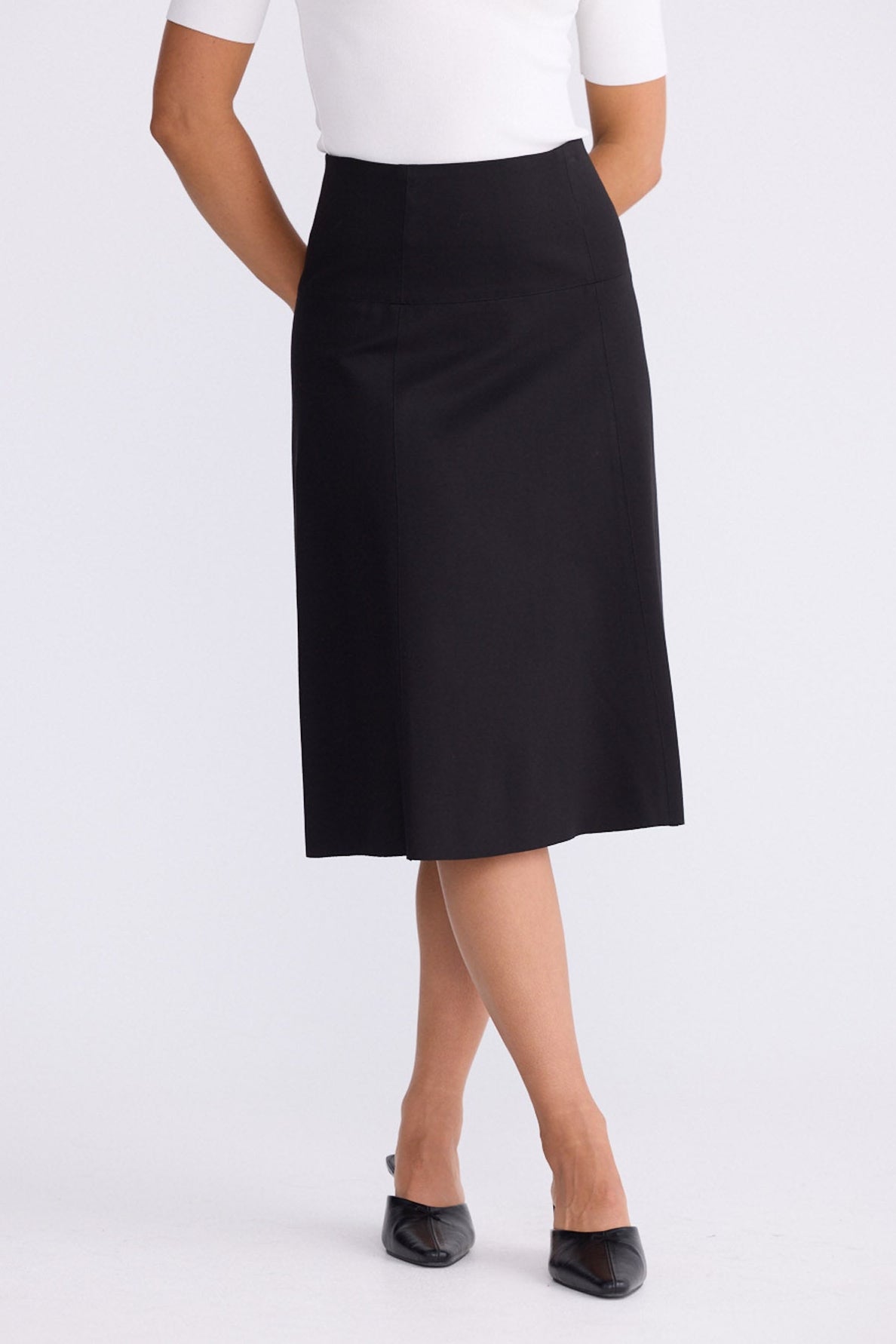 Model wearing Oriane Skirt in black, front view on white background