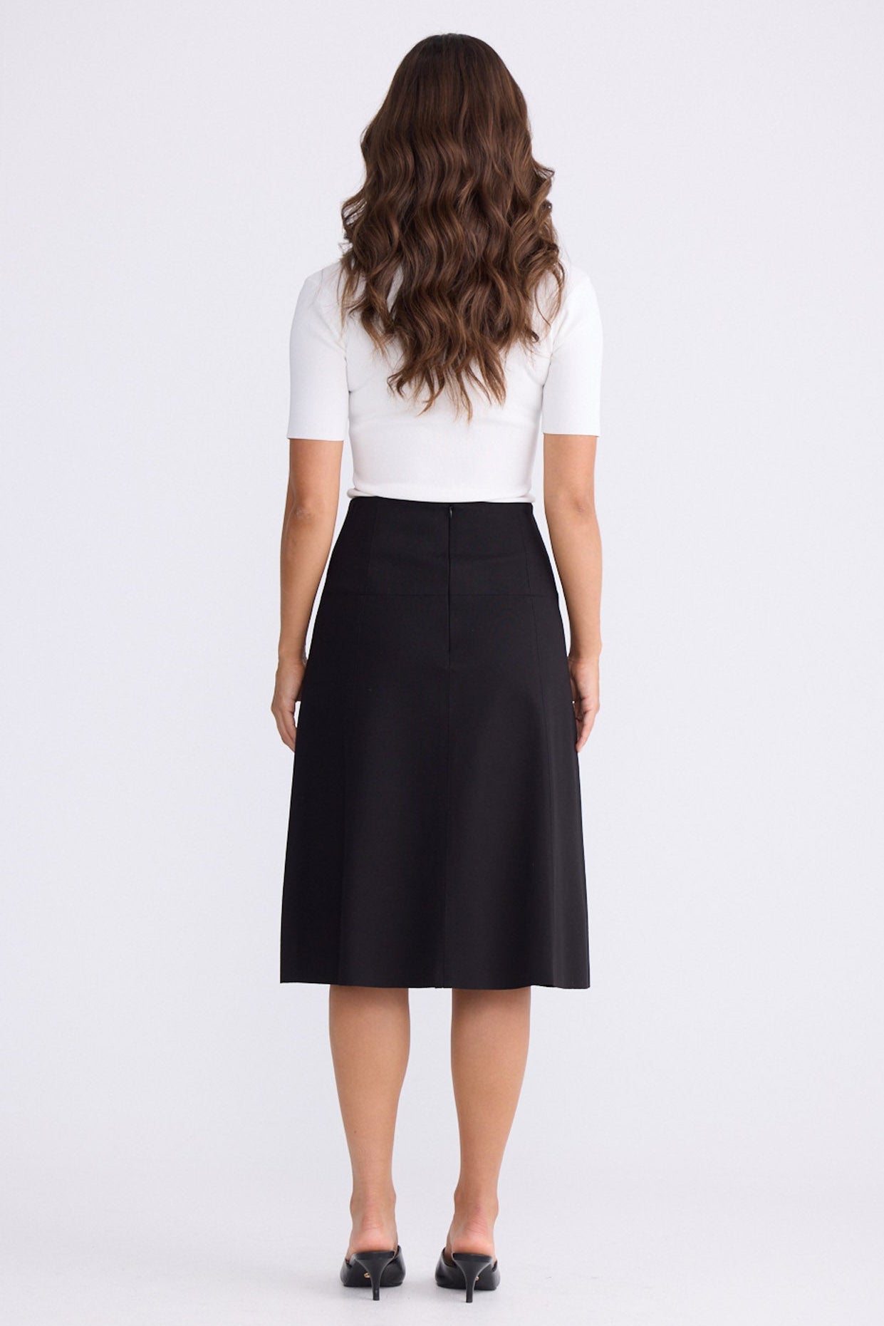 Model wearing Oriane Skirt in black, front view on white background