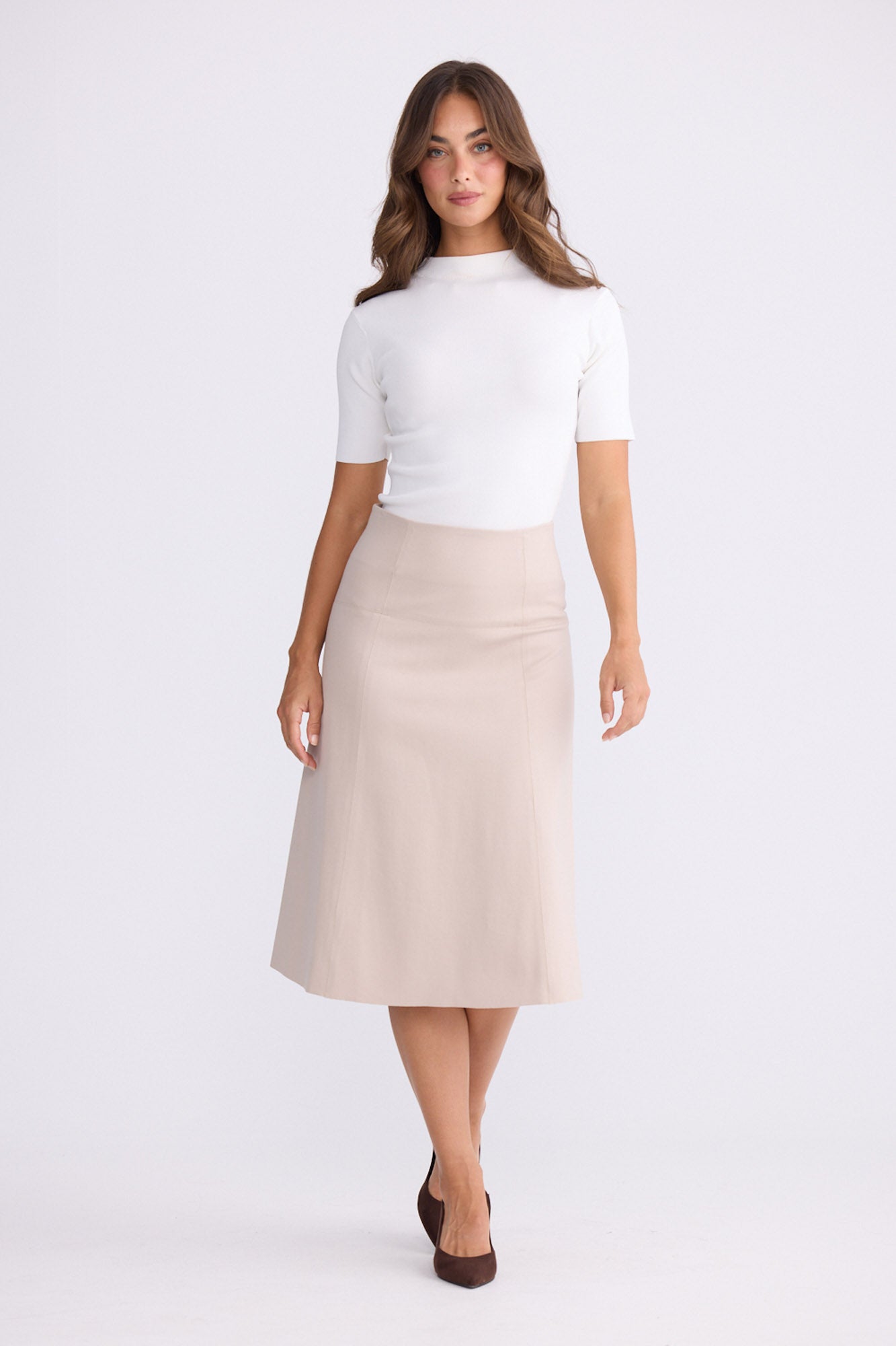 Model wearing Oriane Skirt in beige, front view on white background