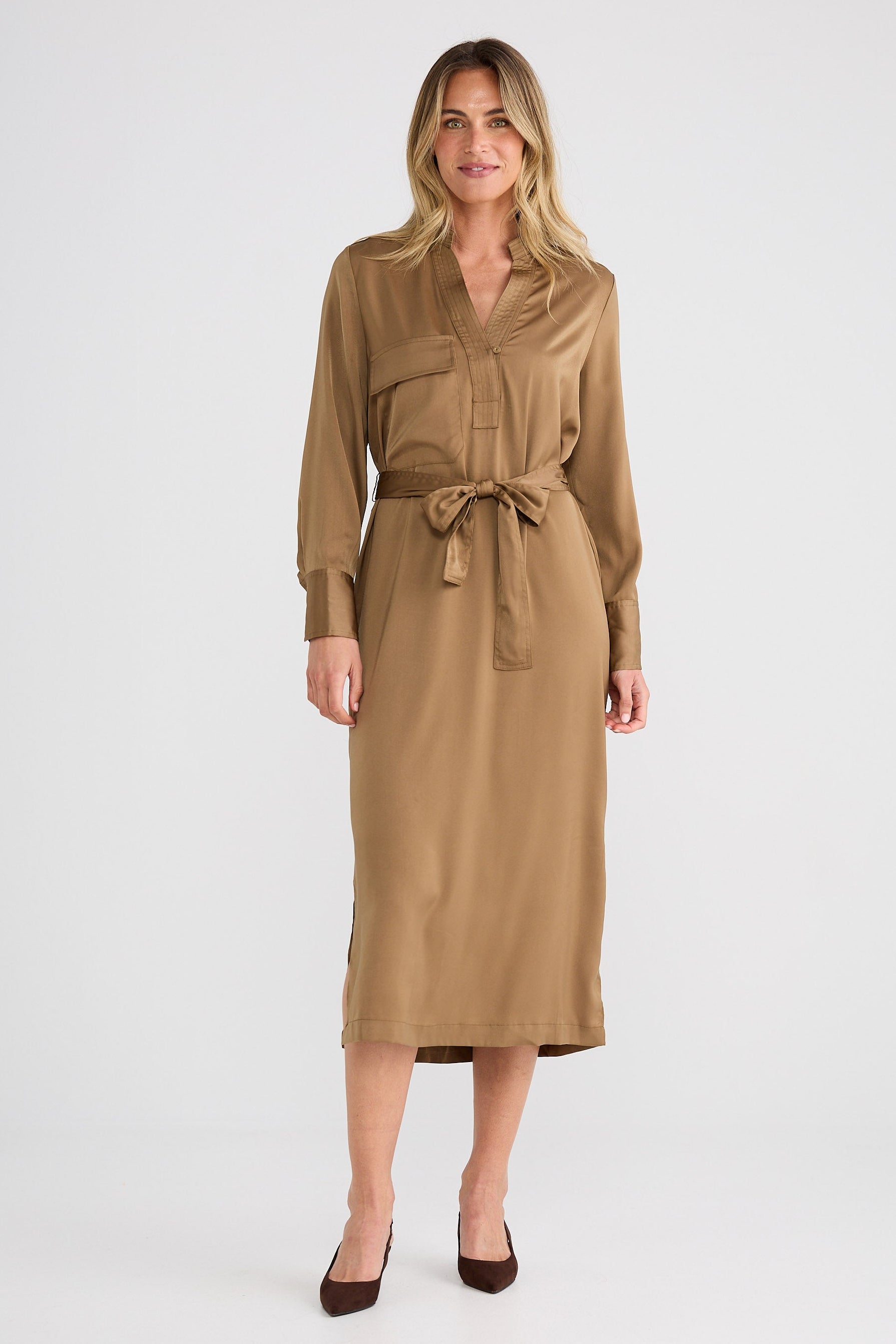 Woman wearing a brown dress with a belt on a white background