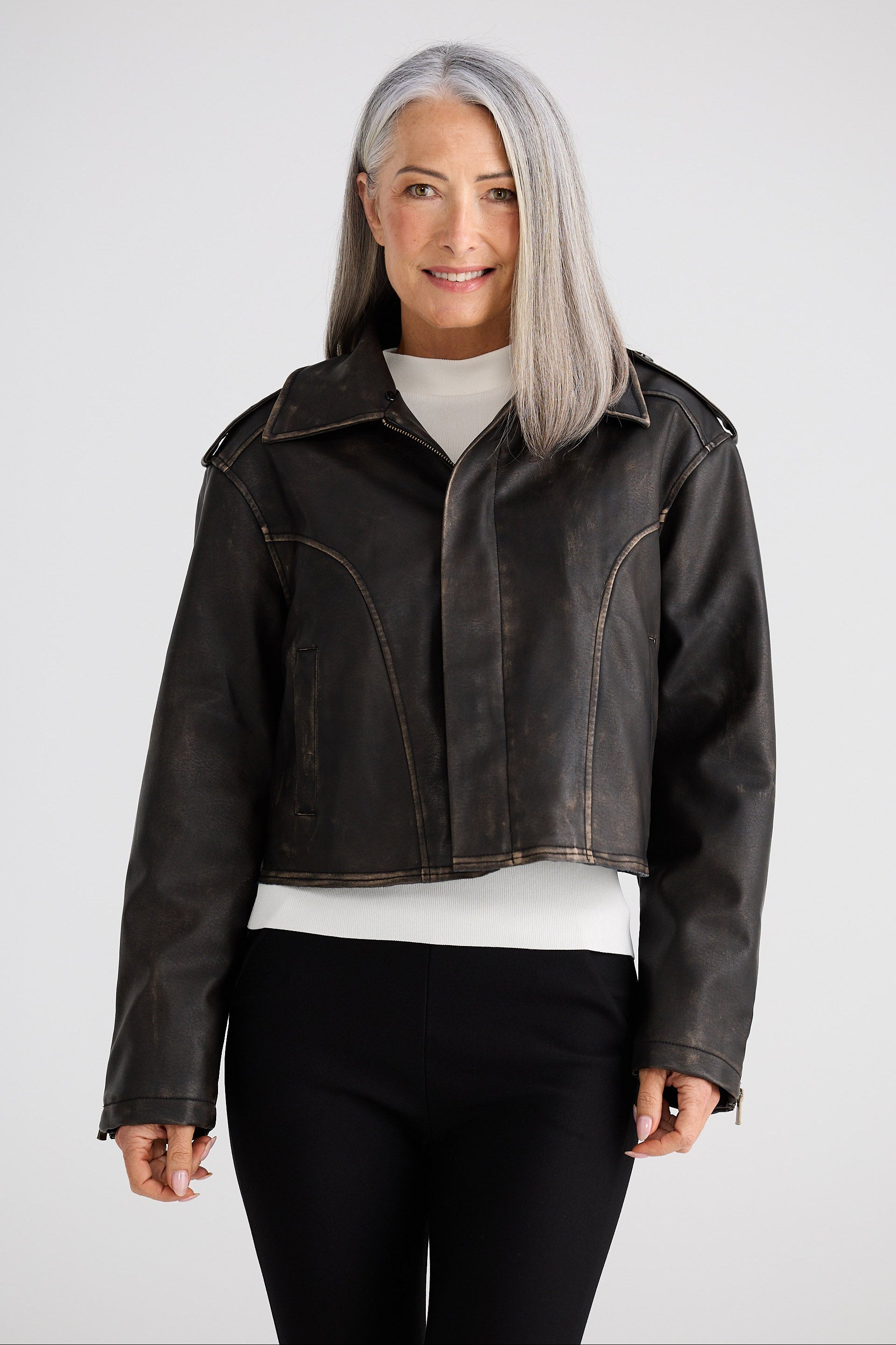 Woman wearing a black leather jacket on a white background