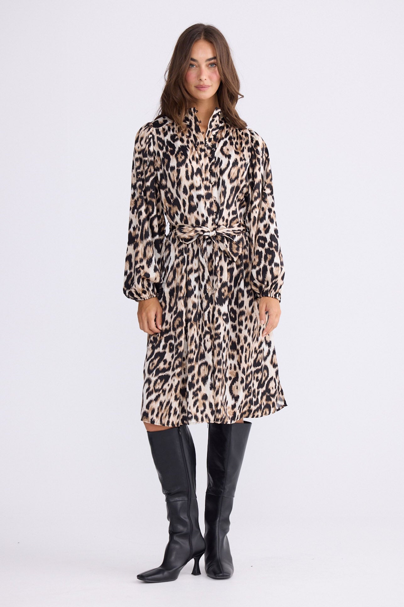 Model wearing Penny Dress in savannah print with high neck and balloon sleeves, front view on white background