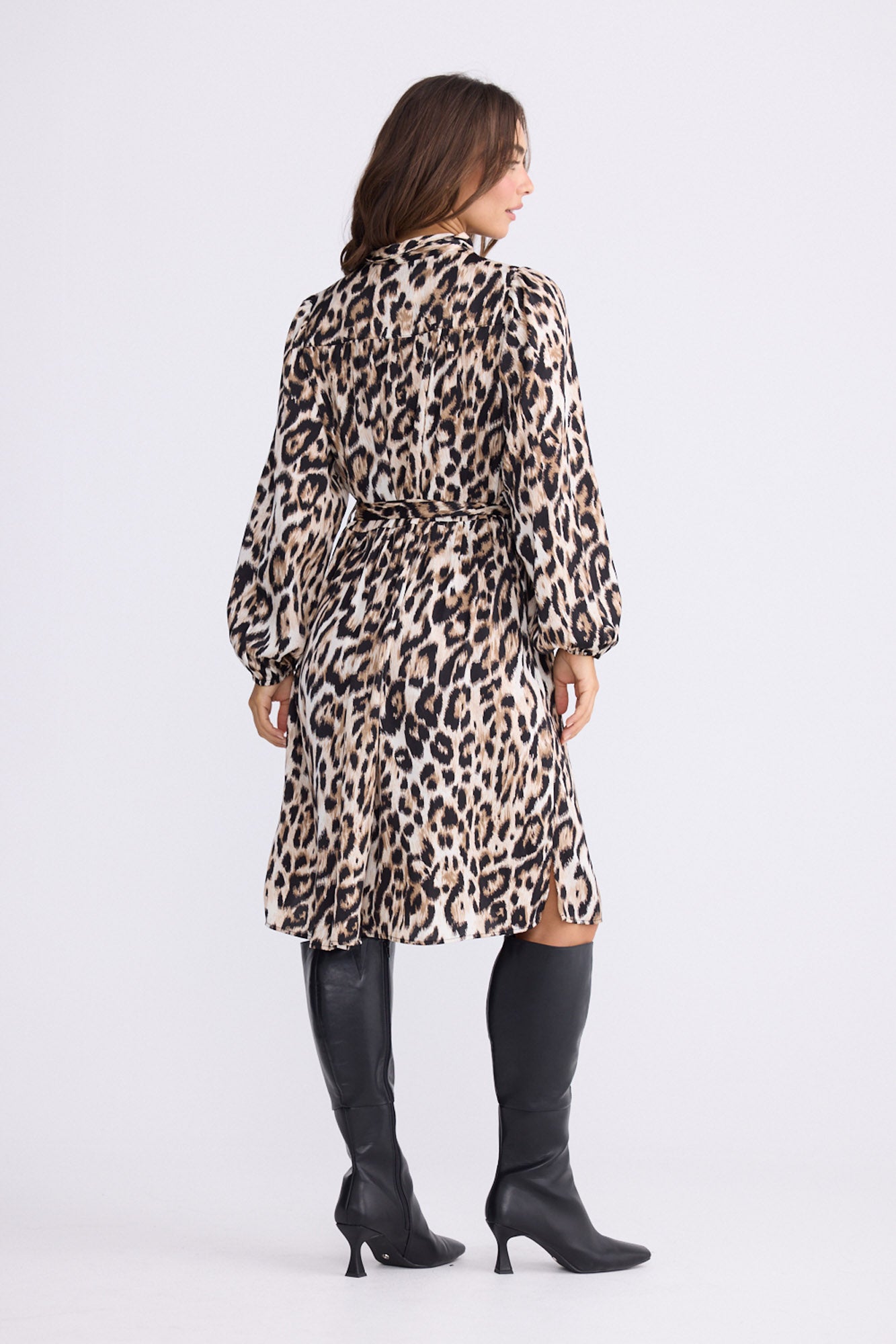 Model wearing Penny Dress in savannah print with high neck and balloon sleeves, back view on white background