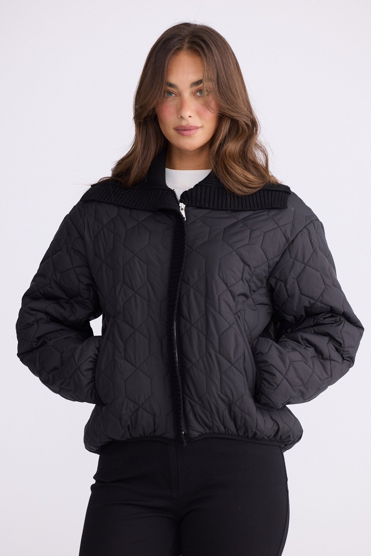 Model wearing Devin Puffer puffer jacket, alternate studio view on white background