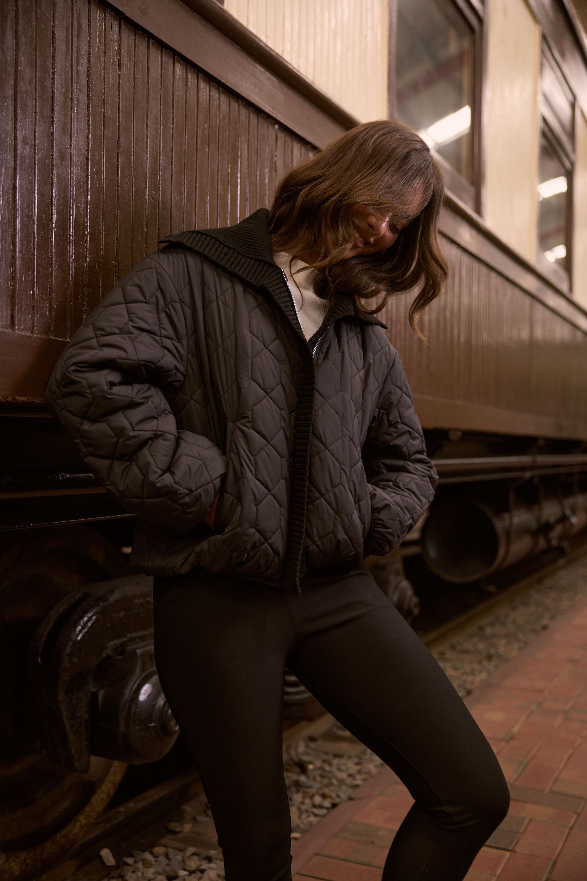 Model wearing Devin Puffer black puffer jacket, alternate studio view on white background