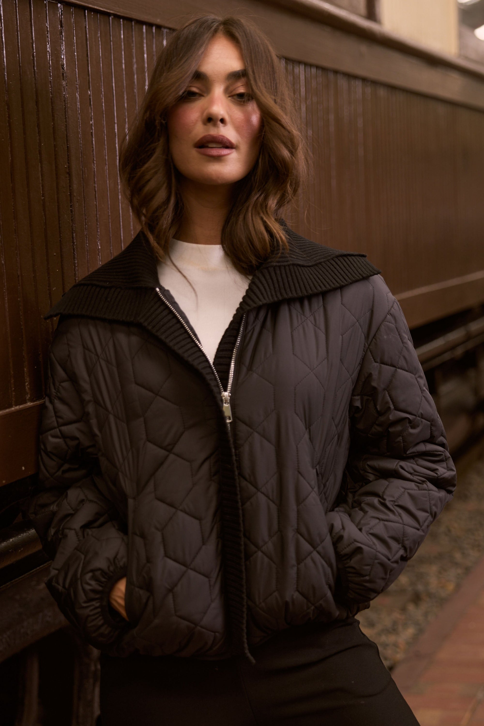 Model wearing Devin Puffer puffer jacket, alternate studio view on white background