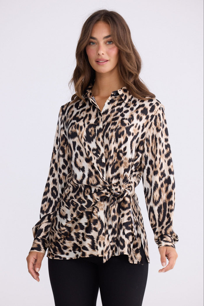 Model wearing Nova Shirt in savannah print with collar and waist tie, back view on white background