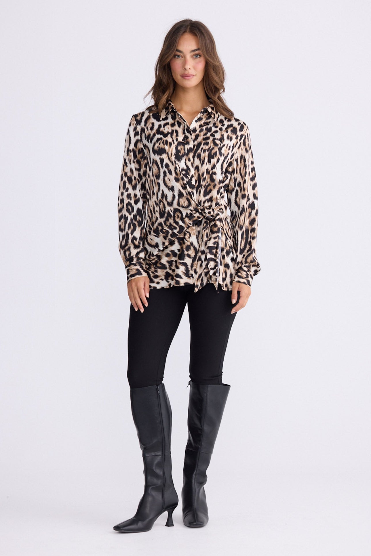Model wearing Nova Shirt in savannah print with collar and waist tie, front view on white background