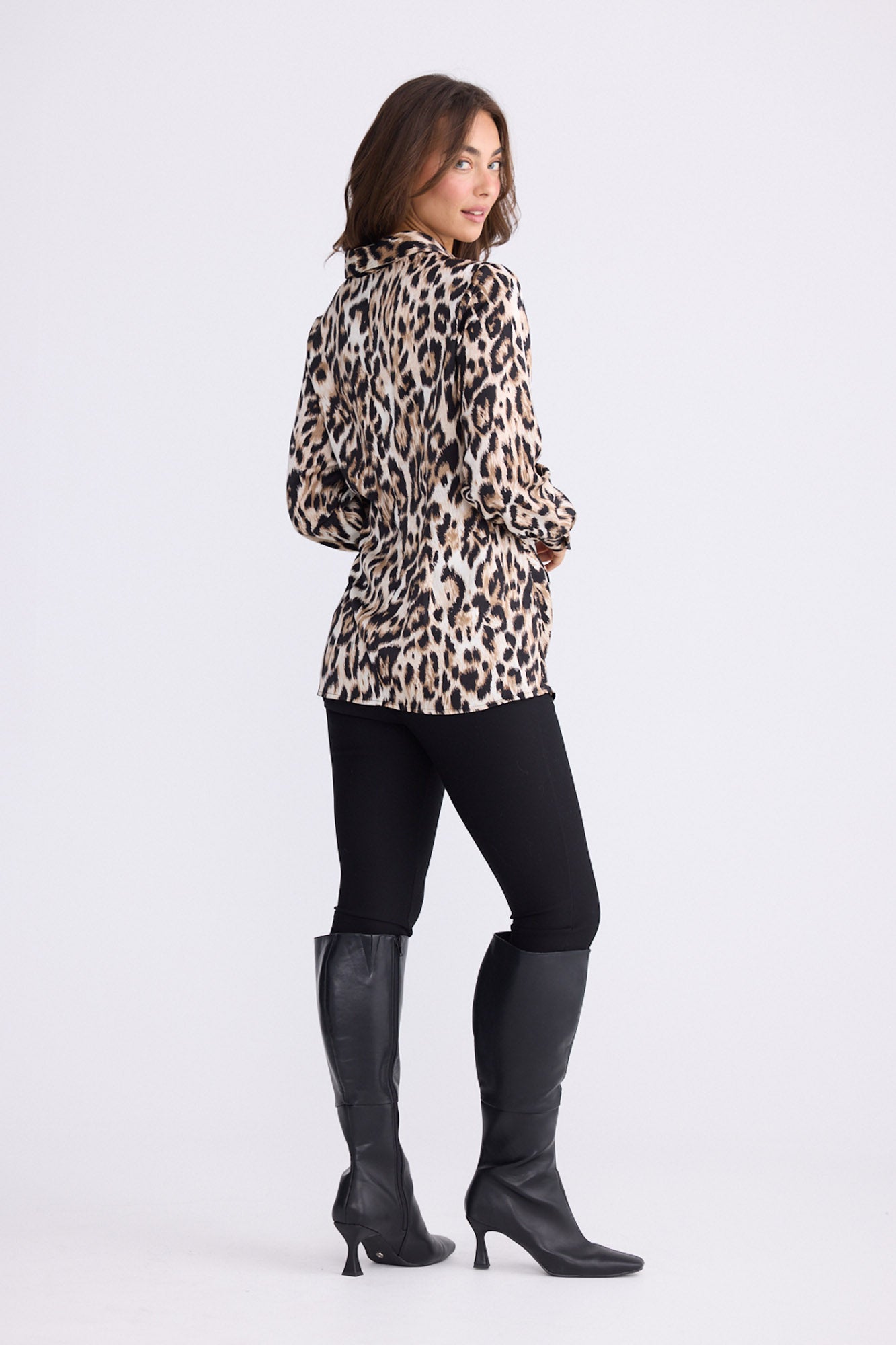 Model wearing Nova Shirt in savannah print with collar and waist tie, front view on white background
