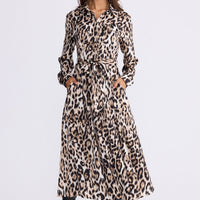 Model wearing Rossellini Long Sleeve Dress in savannah print with shirt collar, front view on white background