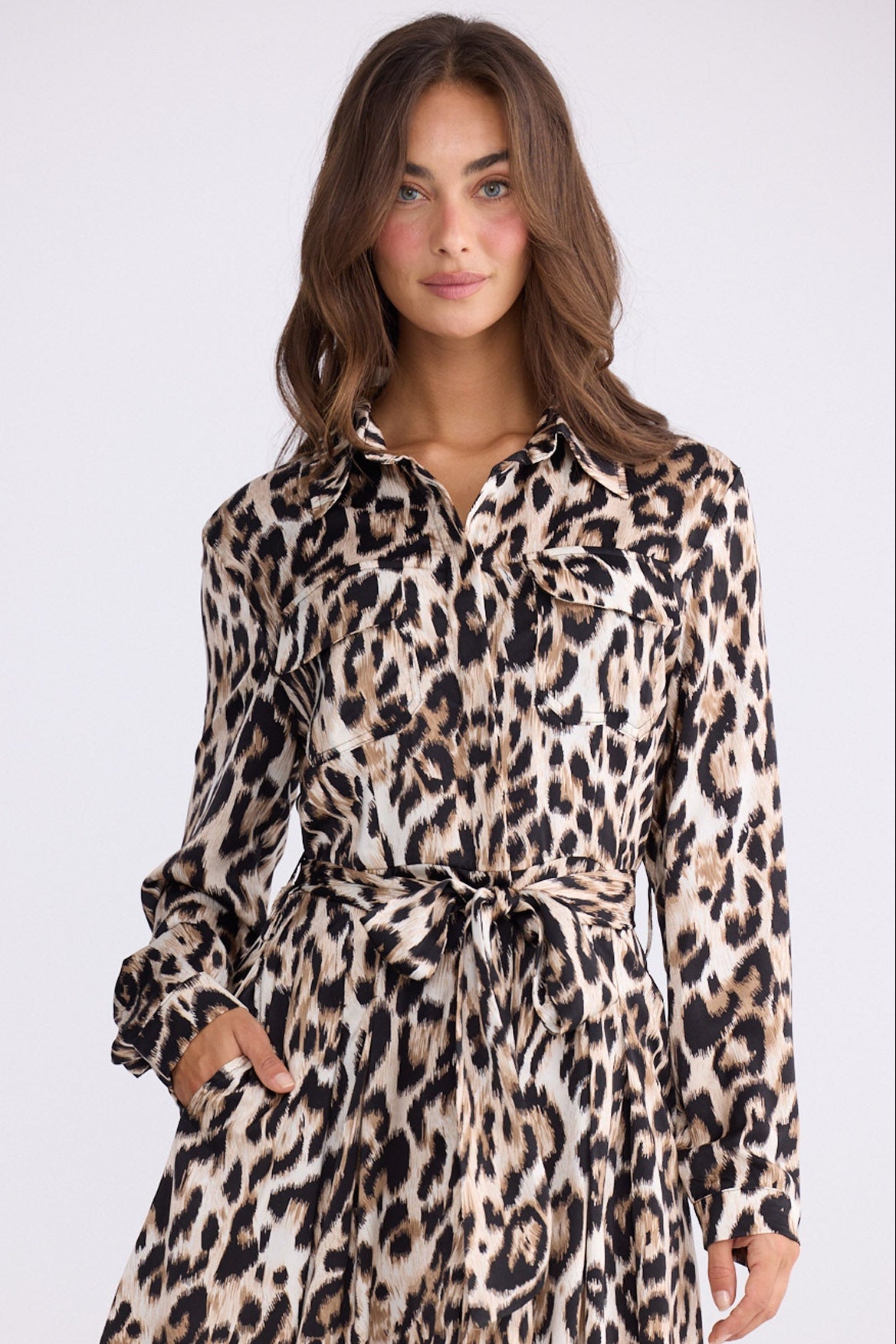 Model wearing Rossellini Long Sleeve Dress in savannah print with shirt collar, side view on white background
