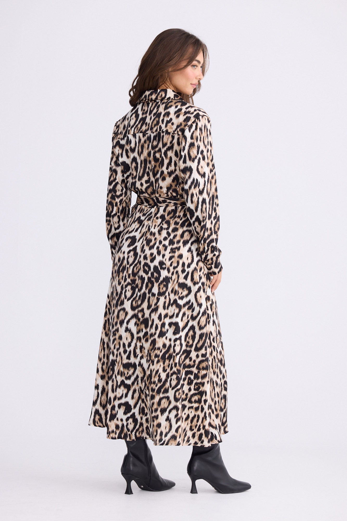 Model wearing Rossellini Long Sleeve Dress in savannah print with shirt collar, back view on white background